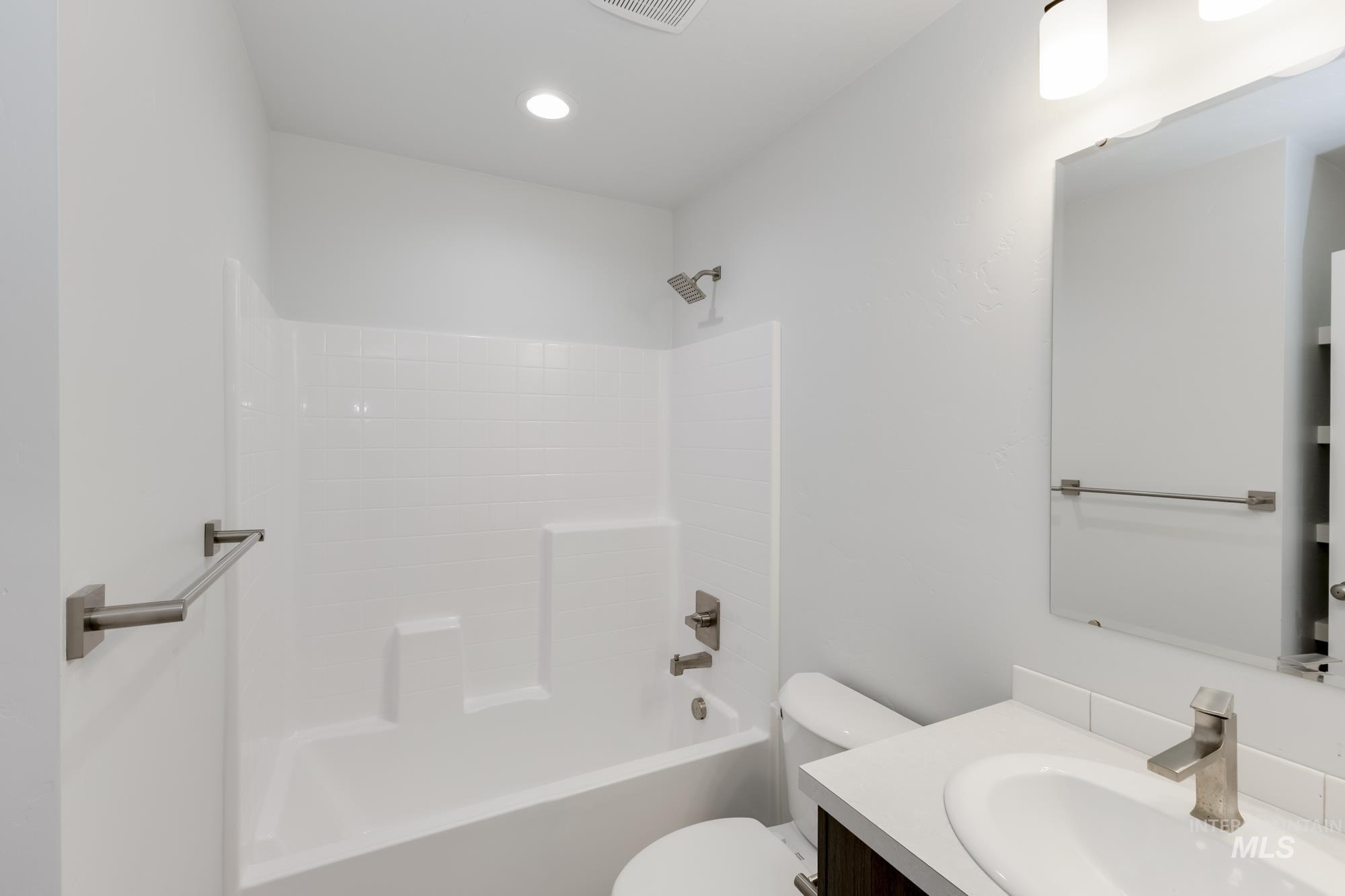 Full bathroom featuring vanity, shower / washtub combination, and recessed lighting