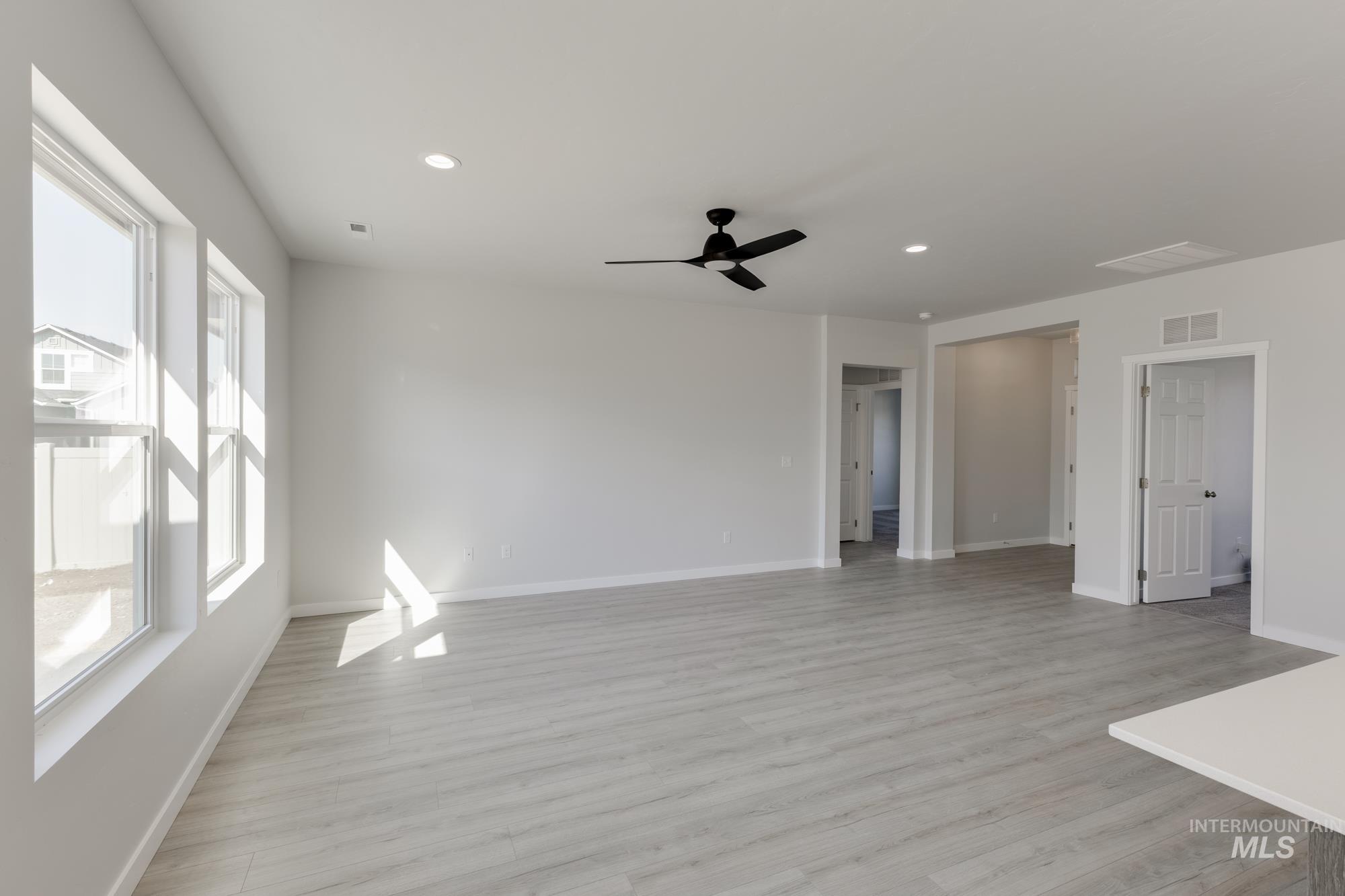 Unfurnished living room featuring light wood-style floors, recessed lighting, and ceiling fan