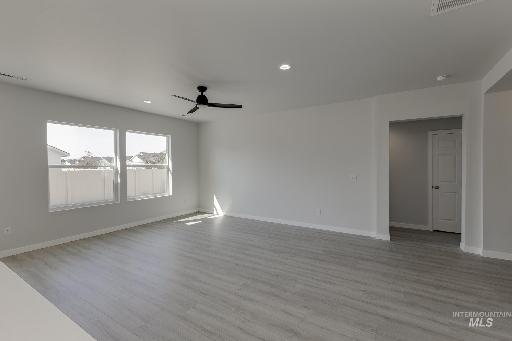 Empty room featuring light wood finished floors, recessed lighting, and ceiling fan