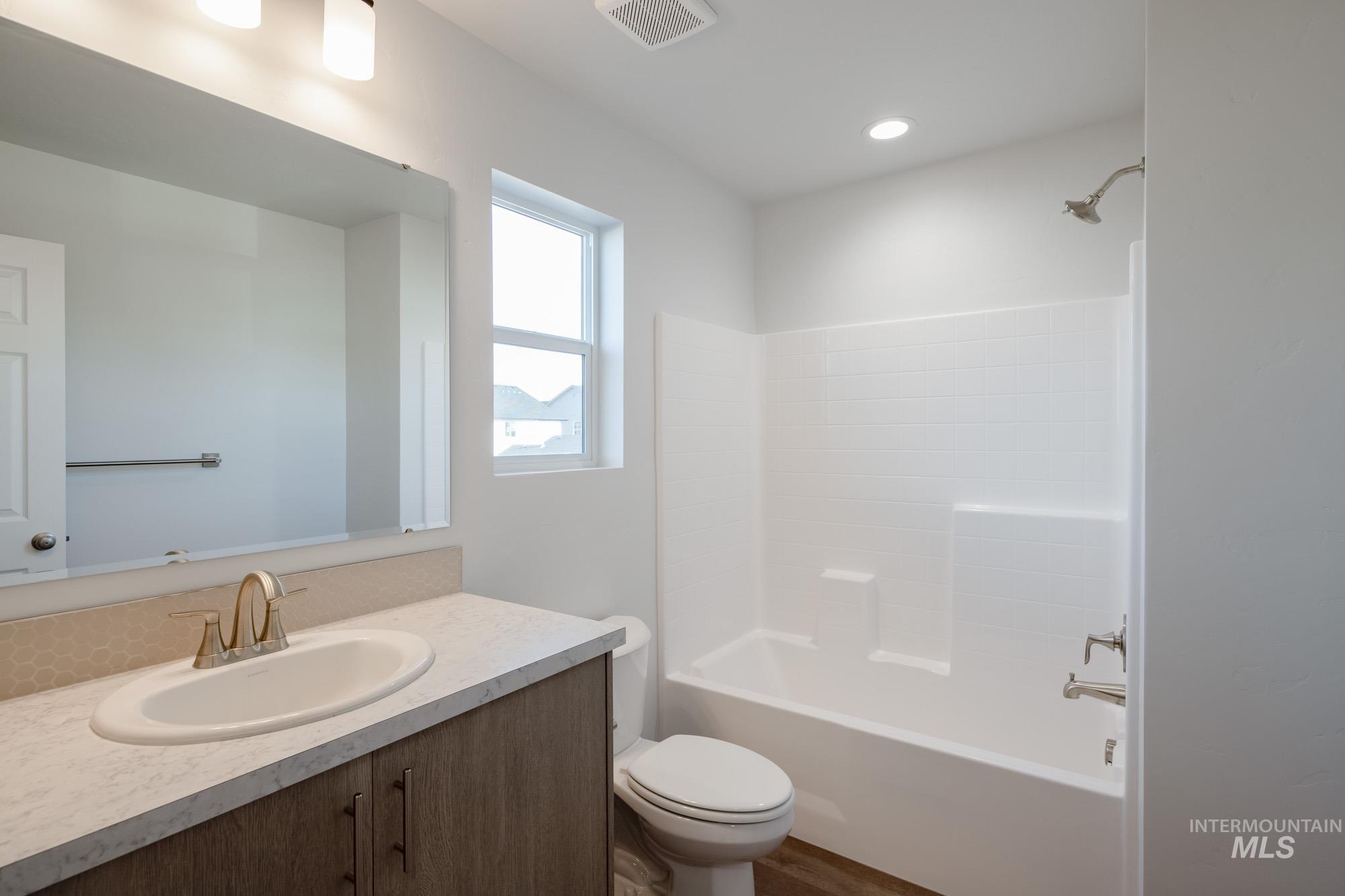 Full bathroom with shower / bathtub combination and vanity