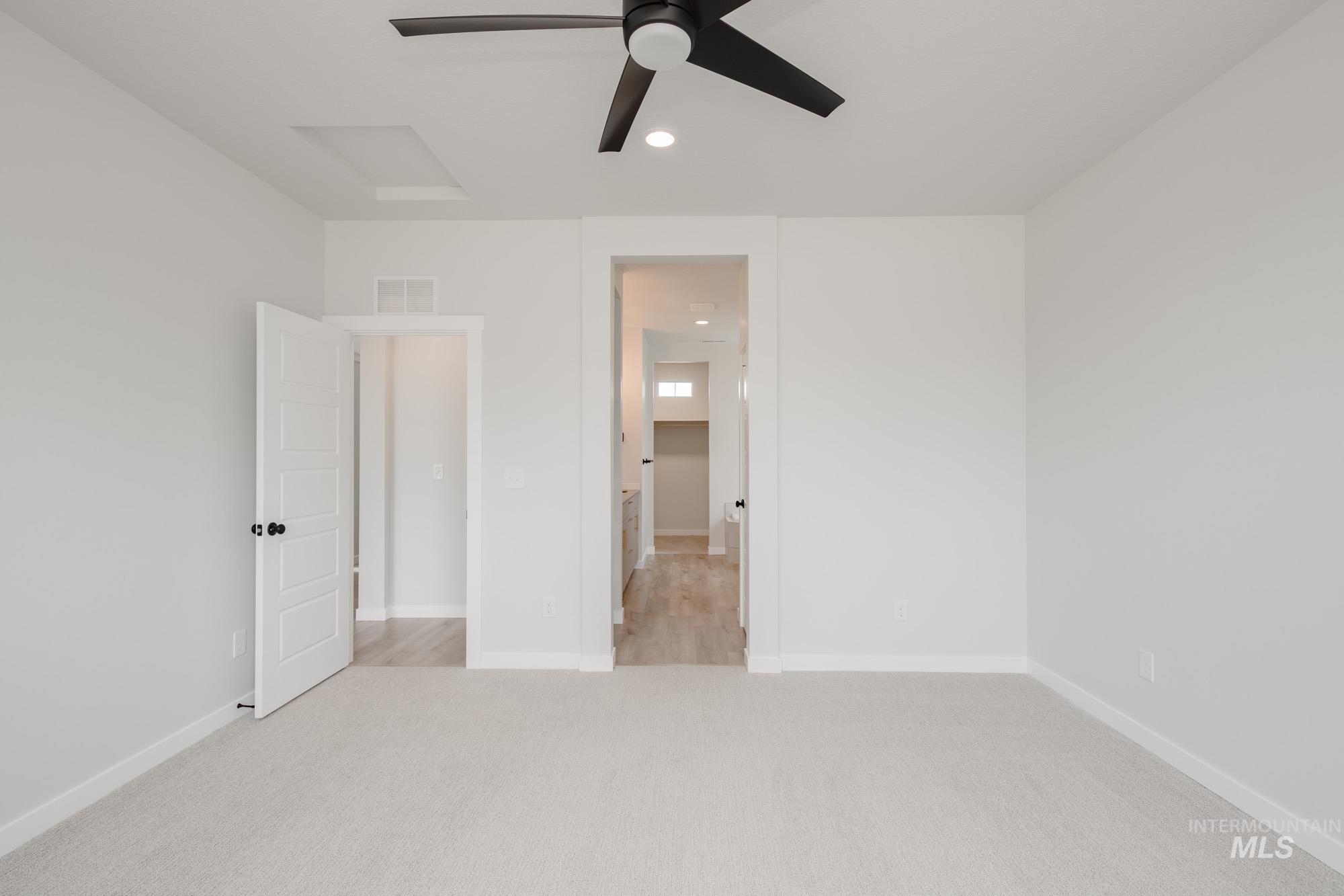 Unfurnished bedroom featuring light colored carpet, recessed lighting, and a ceiling fan