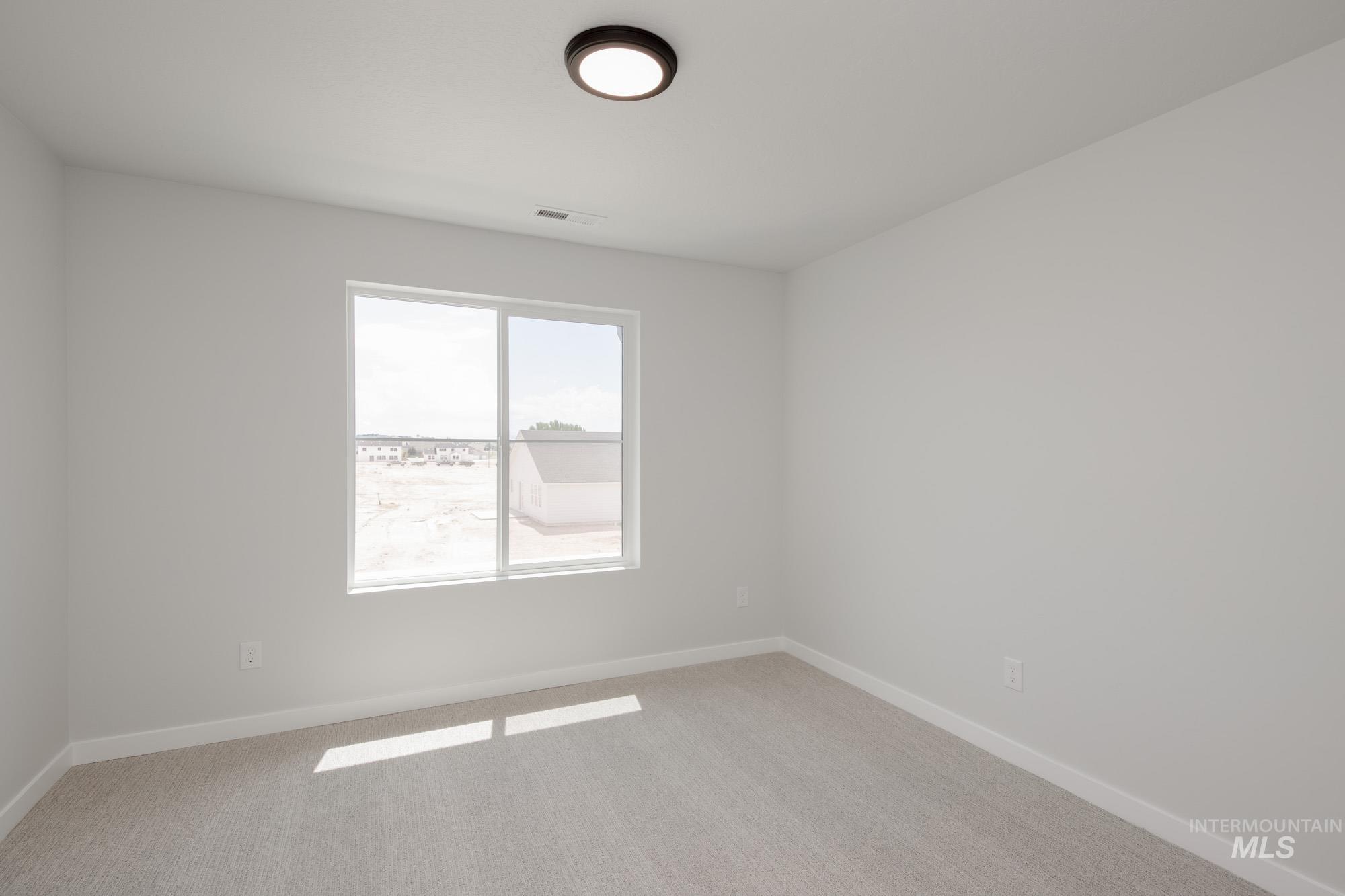 Spare room with light colored carpet