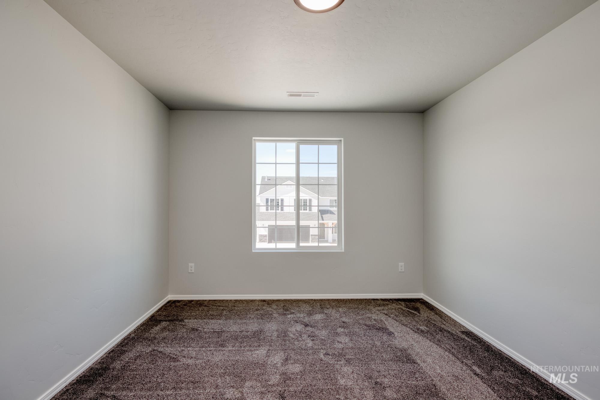 Carpeted empty room with baseboards