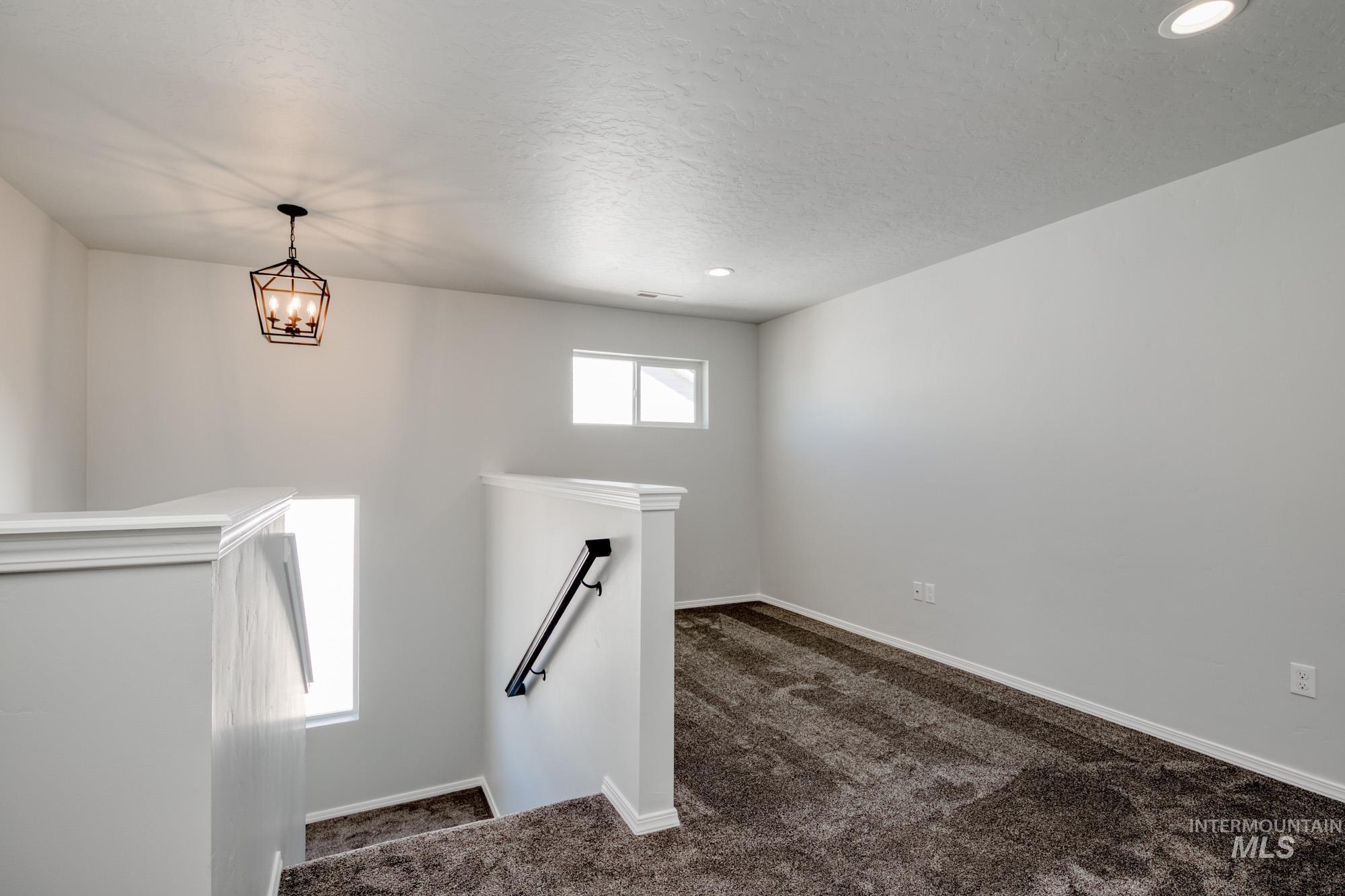 Stairway featuring carpet flooring, recessed lighting, and a textured ceiling