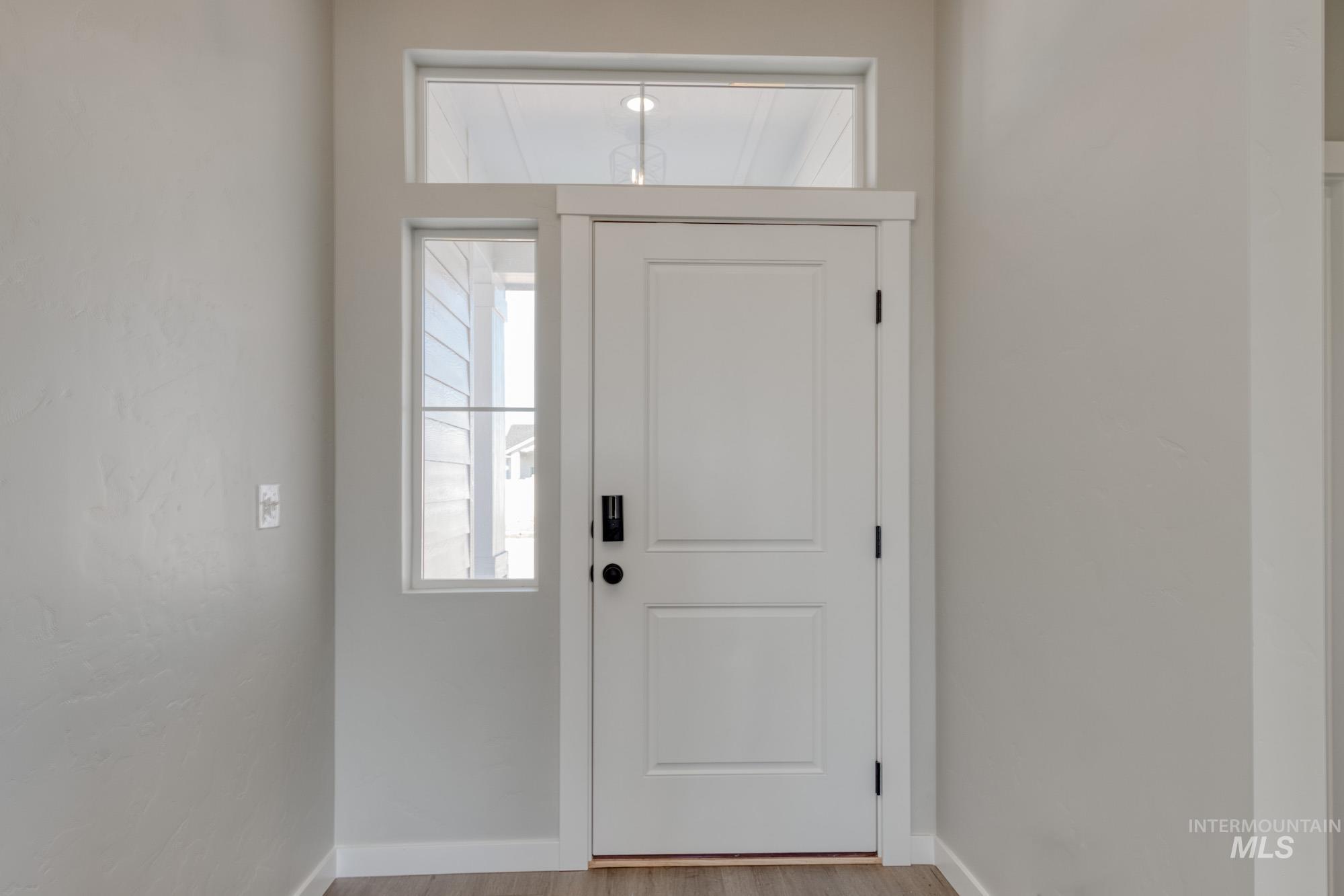Entryway with baseboards and wood finished floors