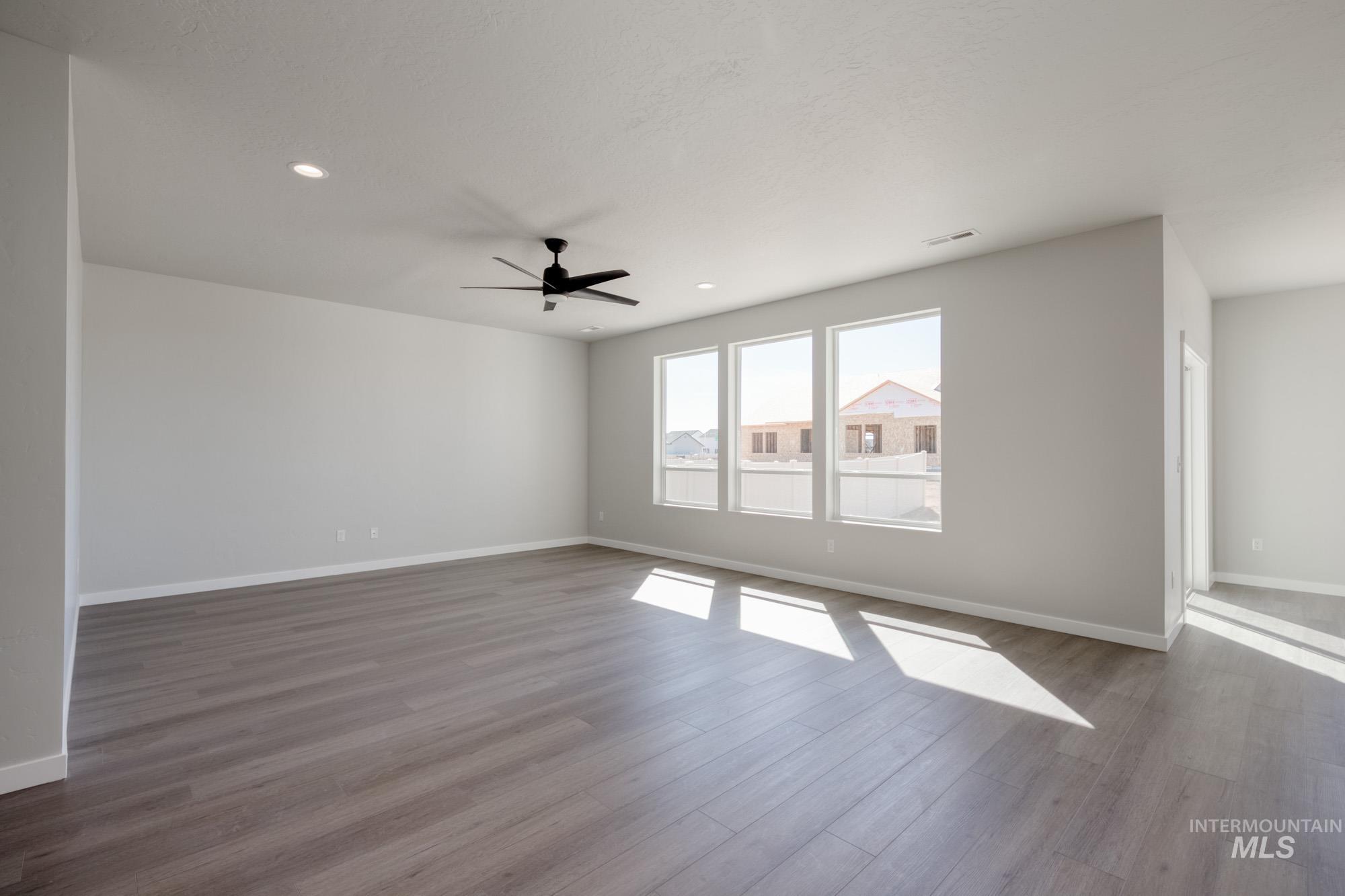 Empty room featuring wood finished floors, recessed lighting, and ceiling fan