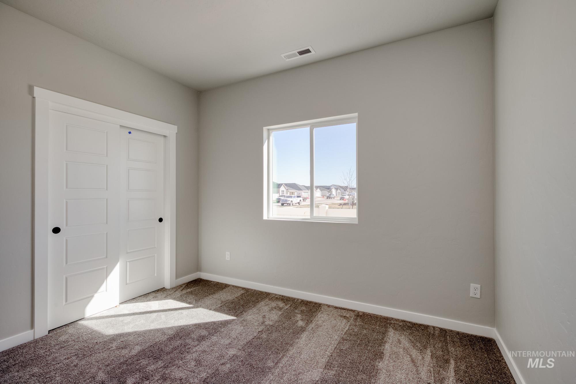 Unfurnished bedroom featuring carpet and a closet