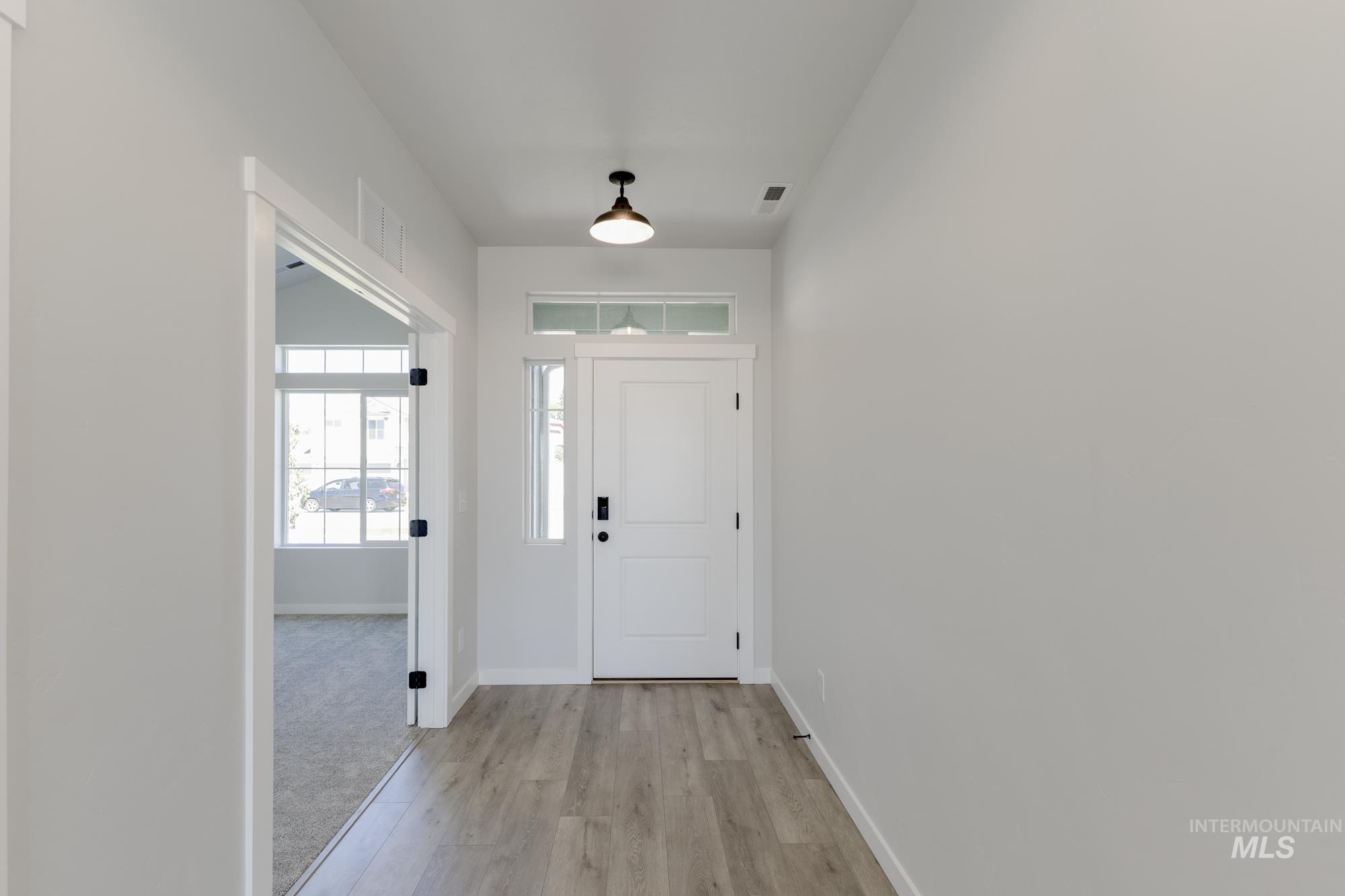 Foyer entrance featuring baseboards and light wood-style flooring