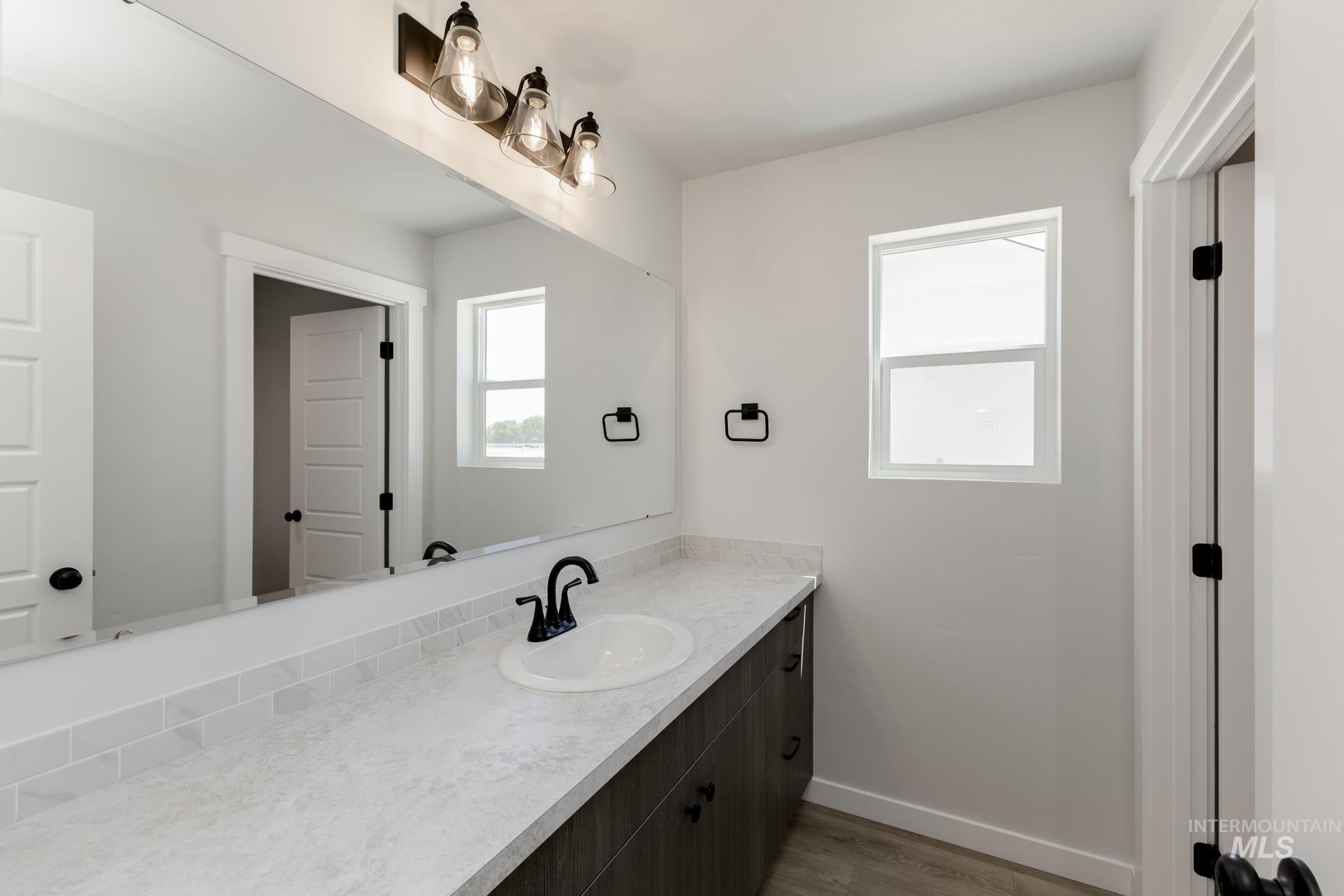 Bathroom featuring vanity and dark wood-style flooring