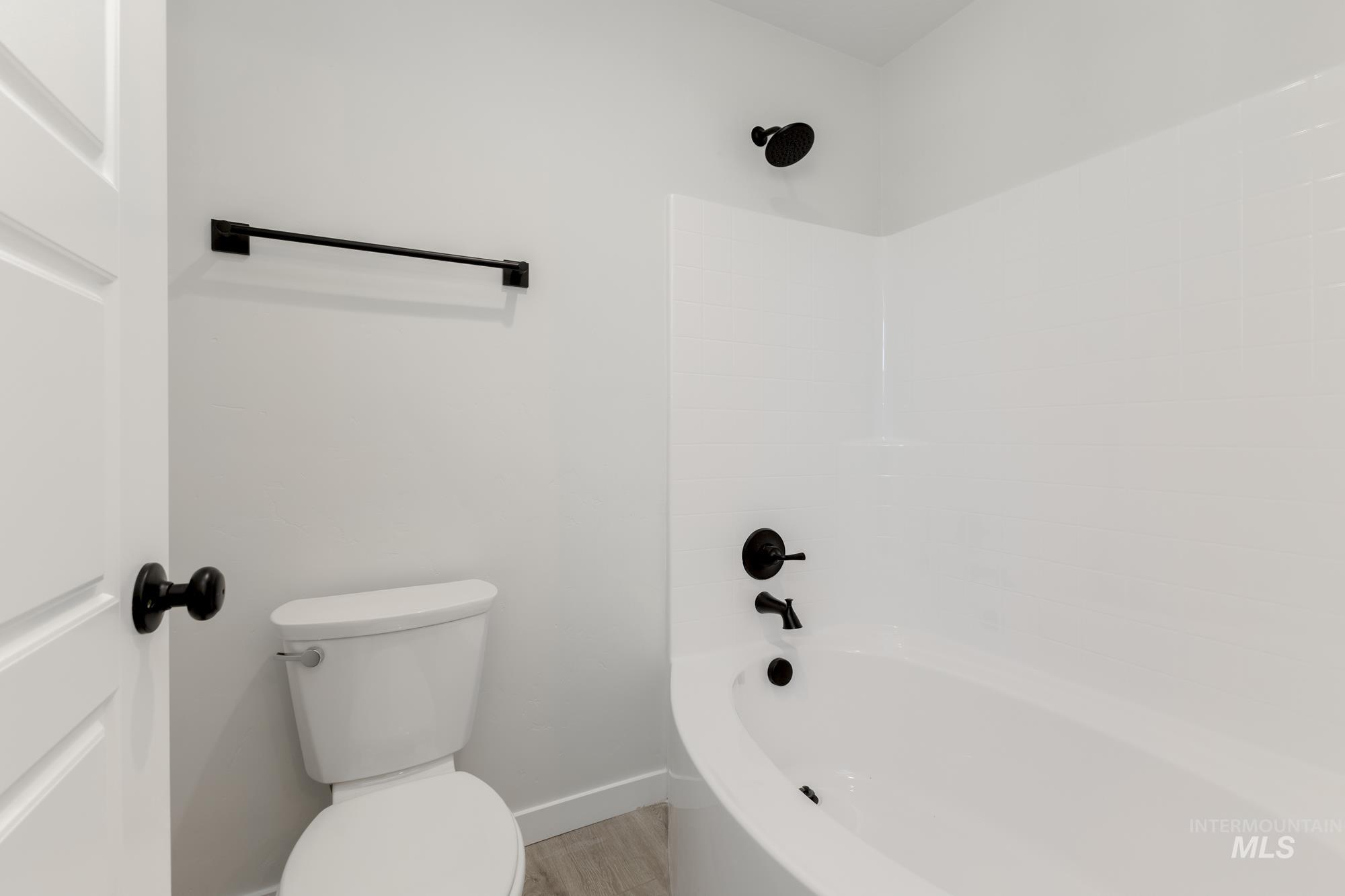Full bathroom featuring shower / bathtub combination and light wood-type flooring