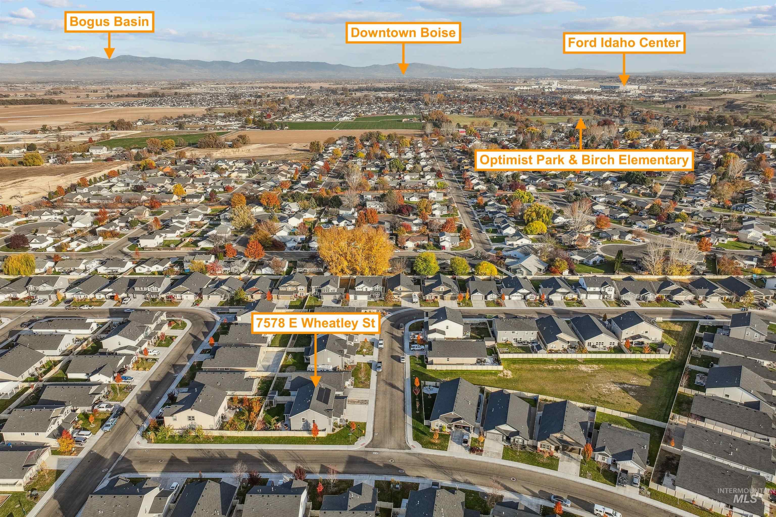 Aerial view of property's location with mountains and nearby suburban area