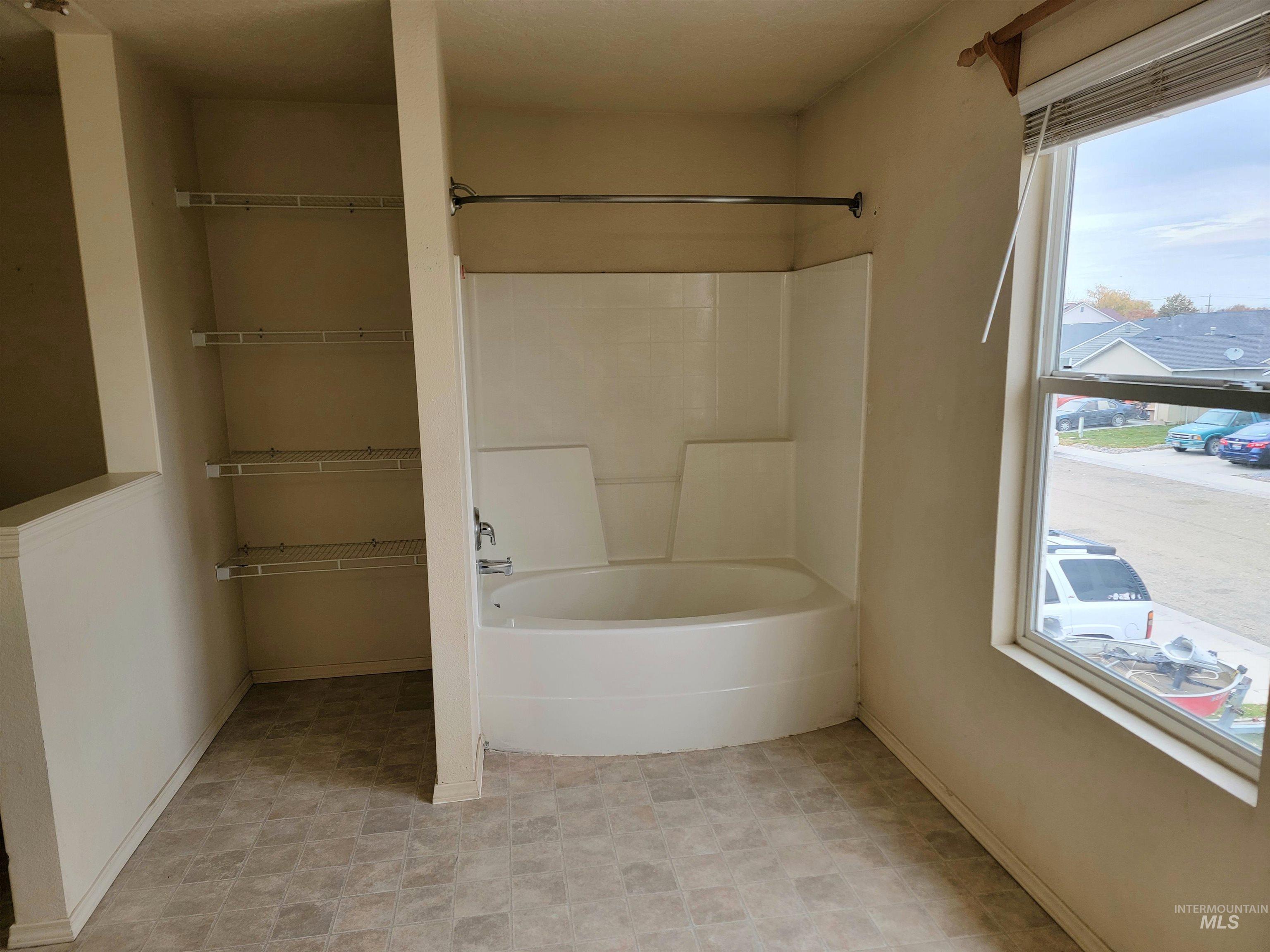 Bathroom with baseboards and  shower combination