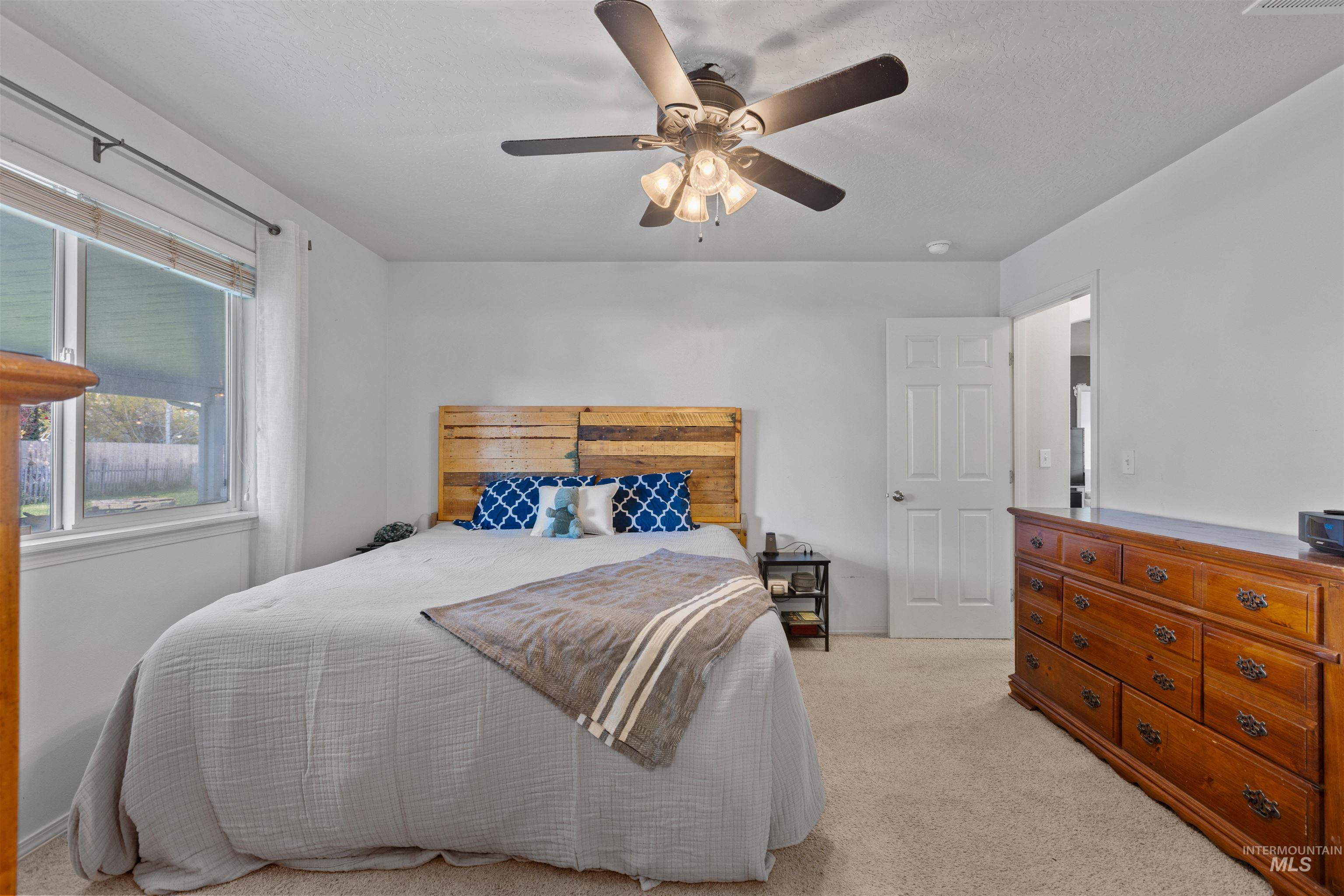 Bedroom featuring light colored carpet and a ceiling fan