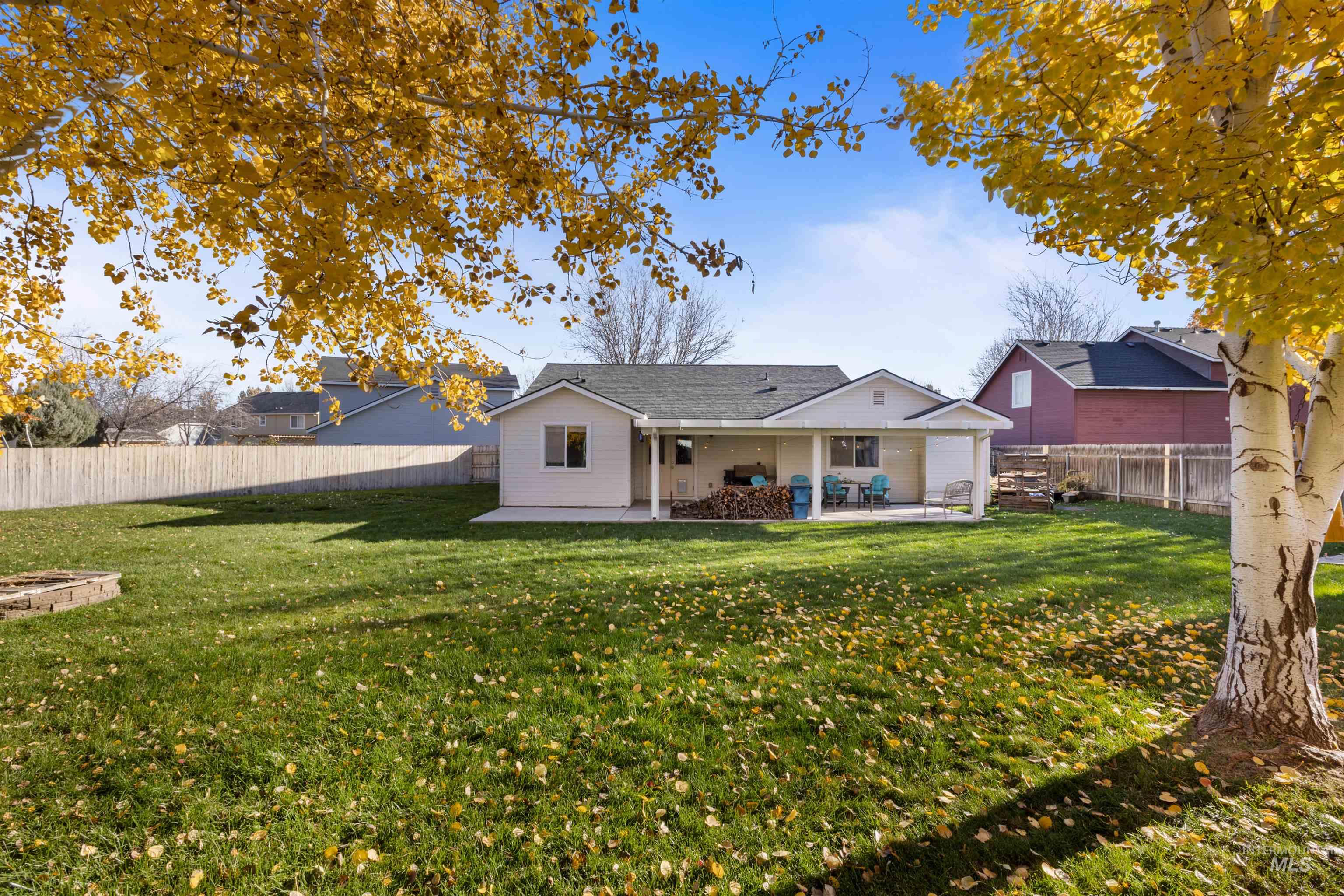 Rear view of house with a patio area and a fenced backyard