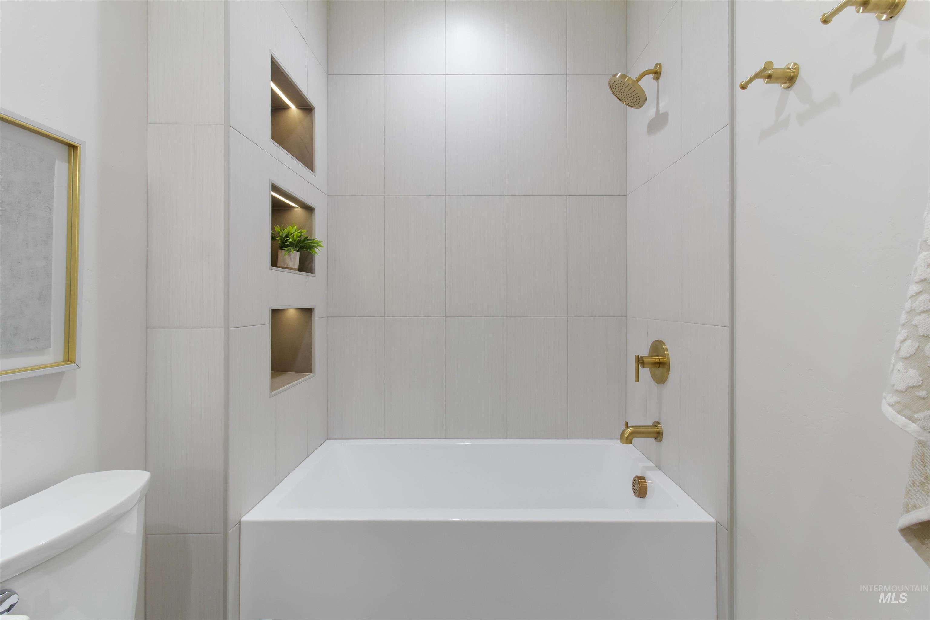 Bathroom with shower / bathtub combination and toilet