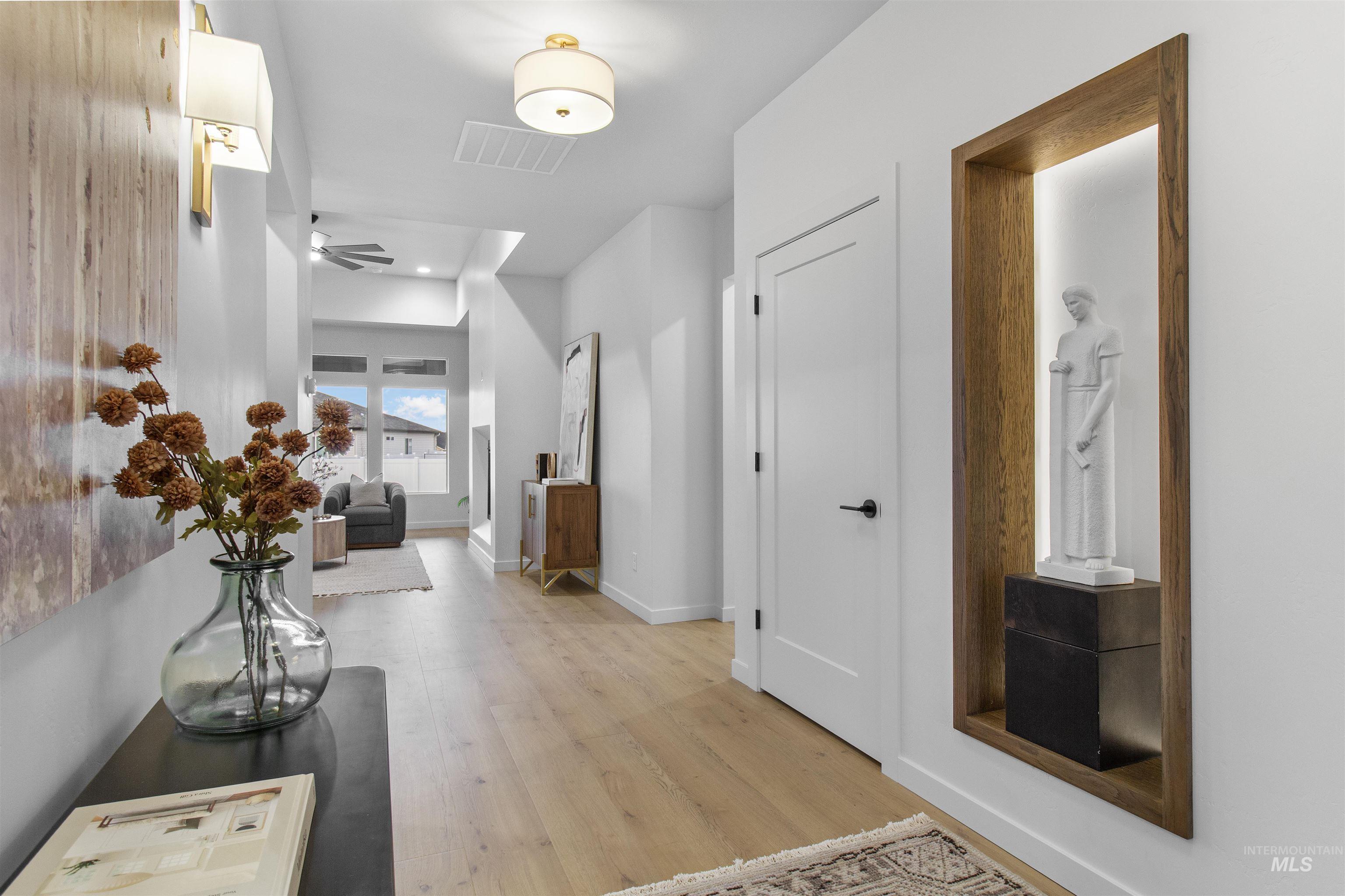 Hall featuring light wood-style floors and baseboards