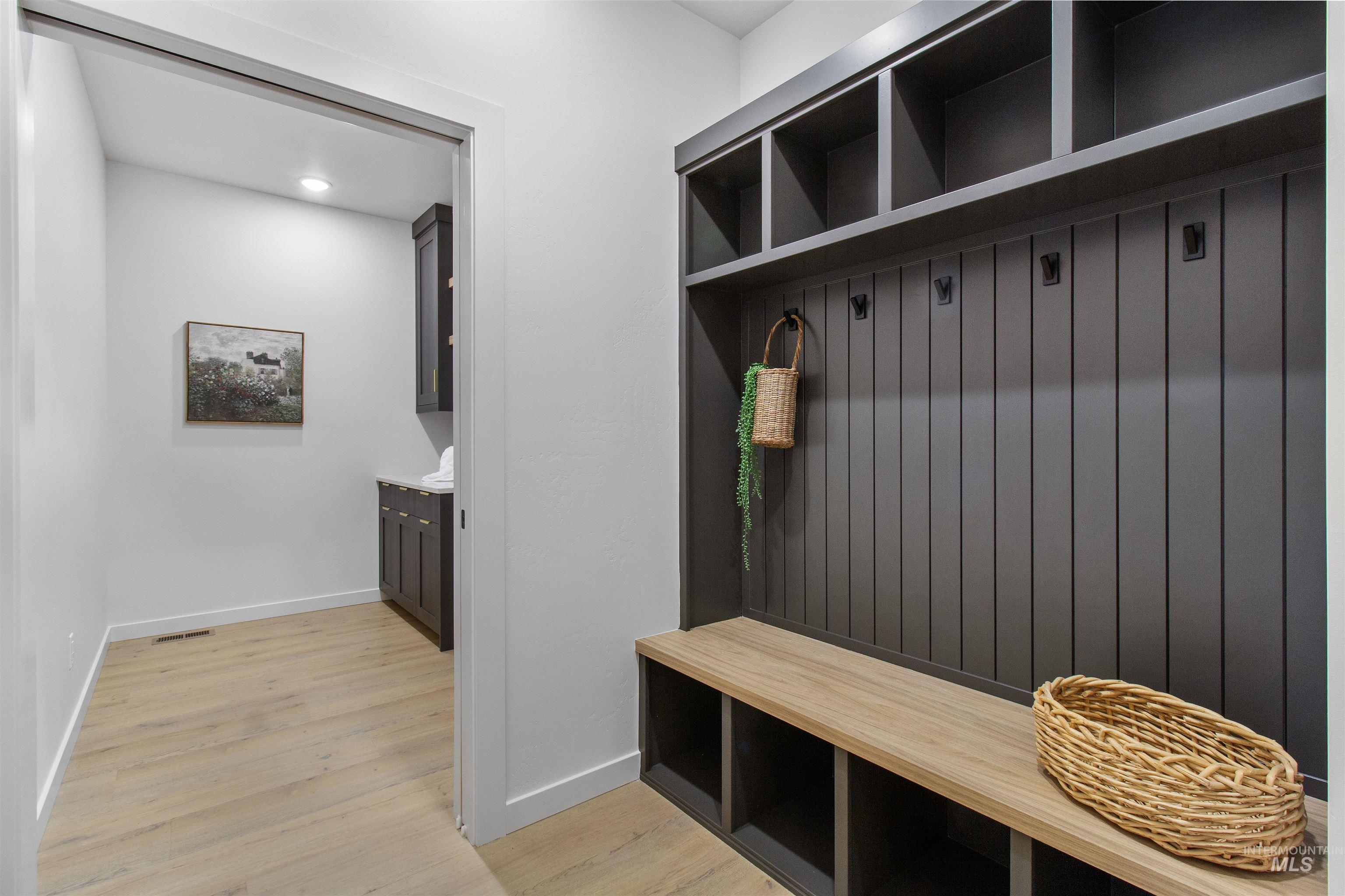 Mudroom with light wood-type flooring and recessed lighting