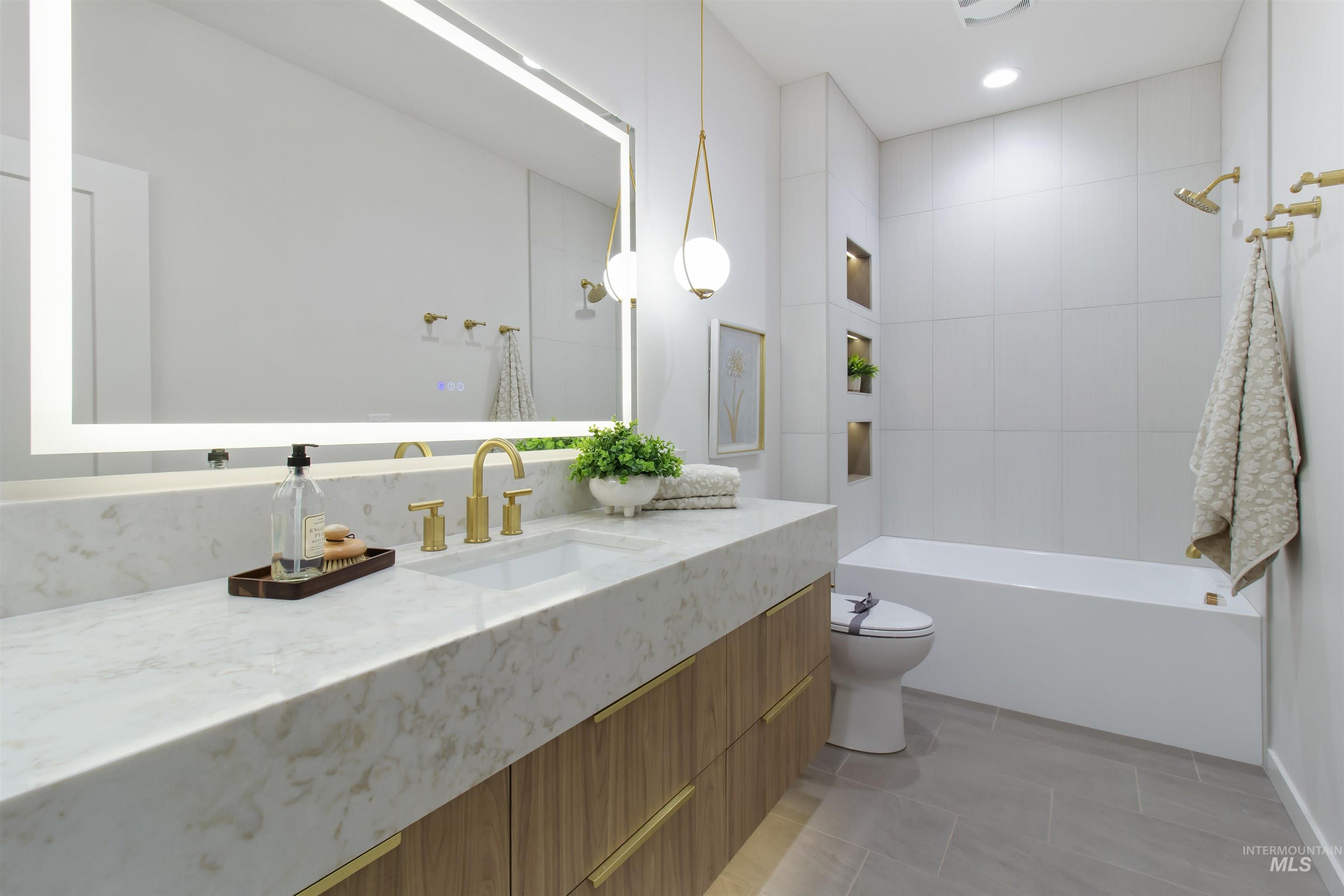 Bathroom featuring vanity, light tile patterned floors,  shower combination, and recessed lighting