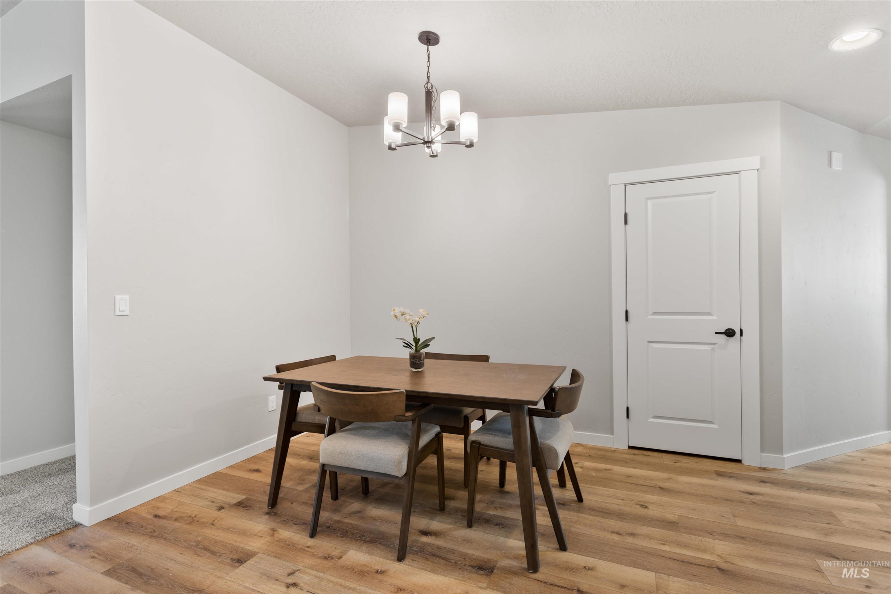 Dining room featuring a chandelier, light wood-type flooring, and recessed lighting