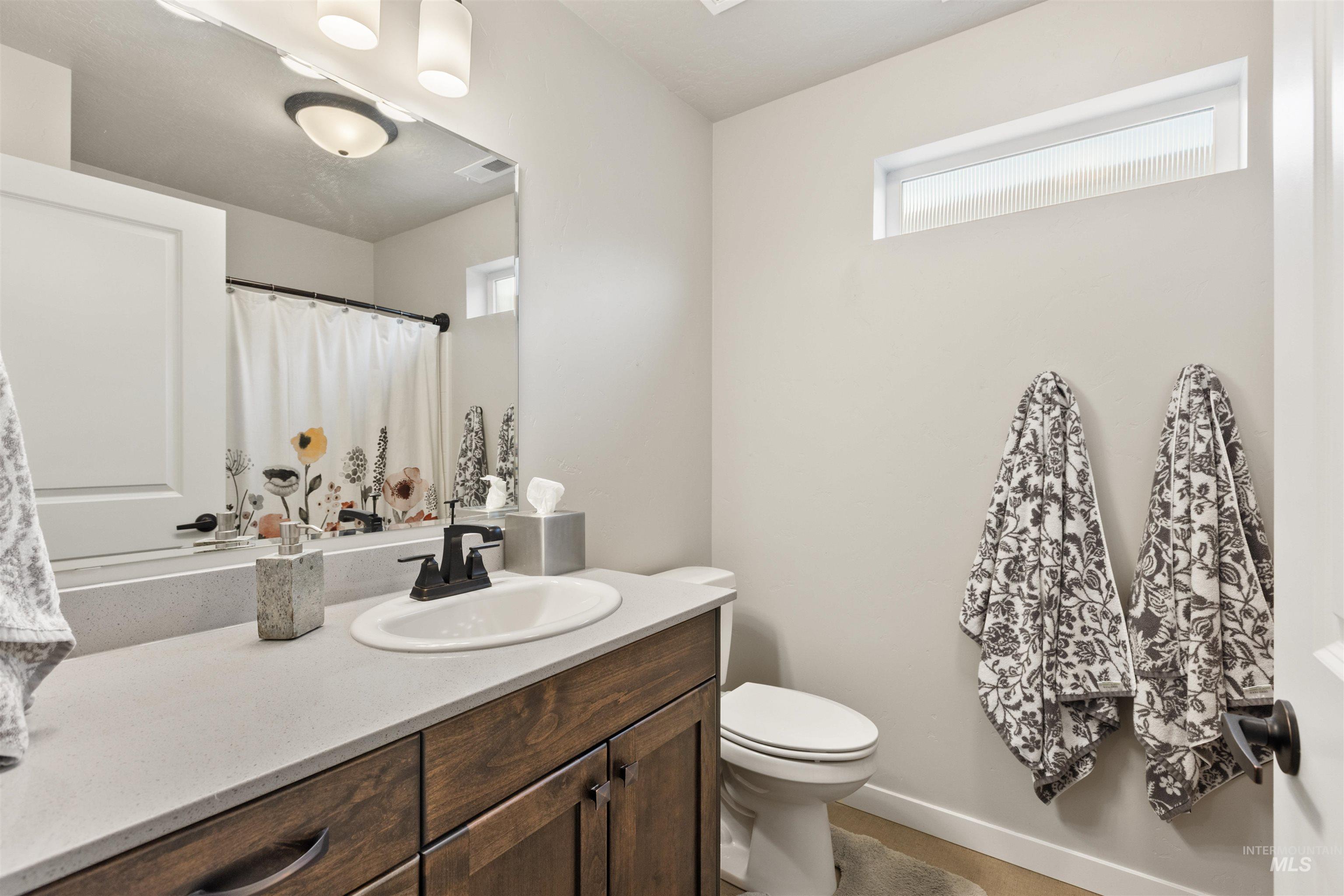 Bathroom with vanity and curtained shower