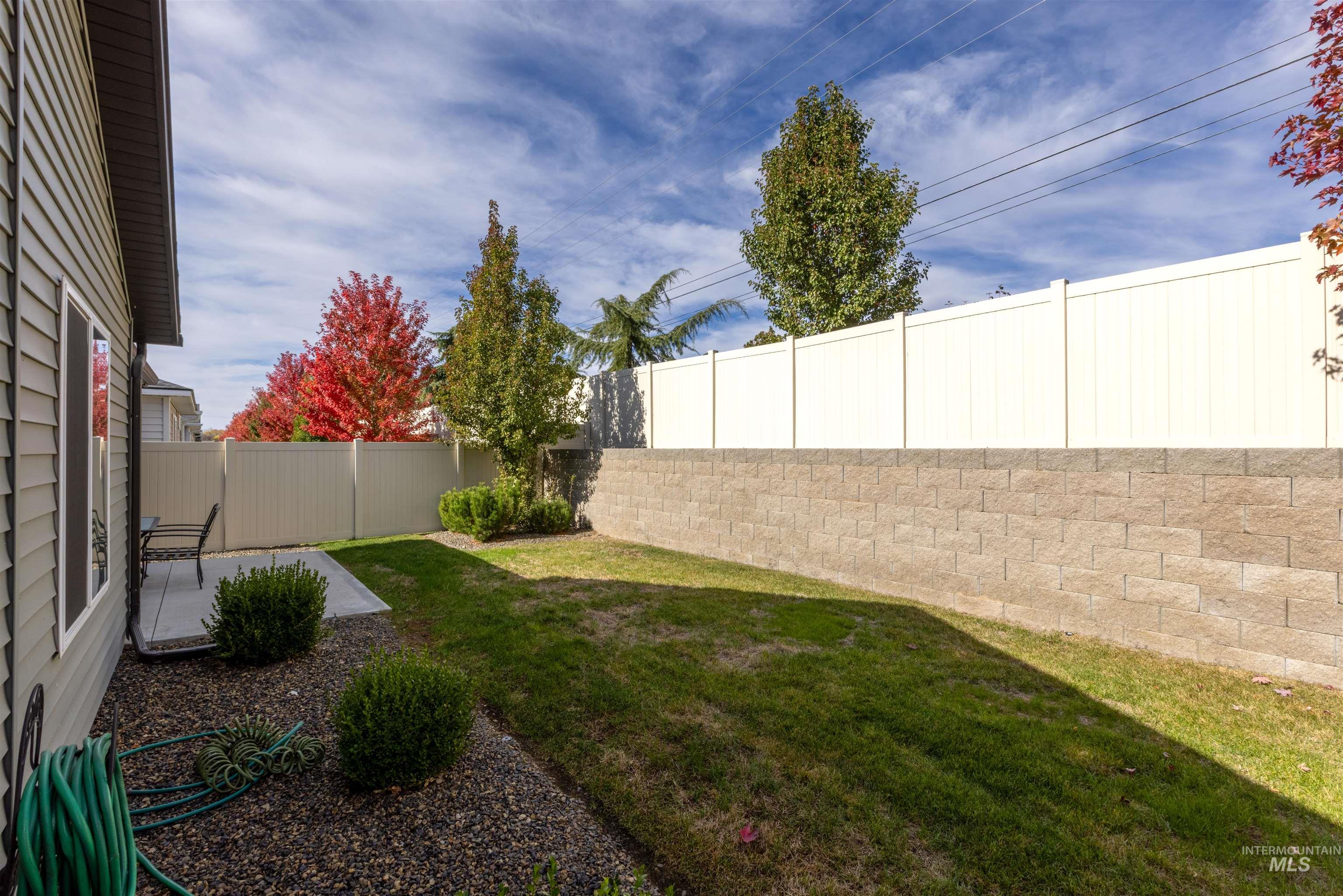 Fenced backyard with a patio
