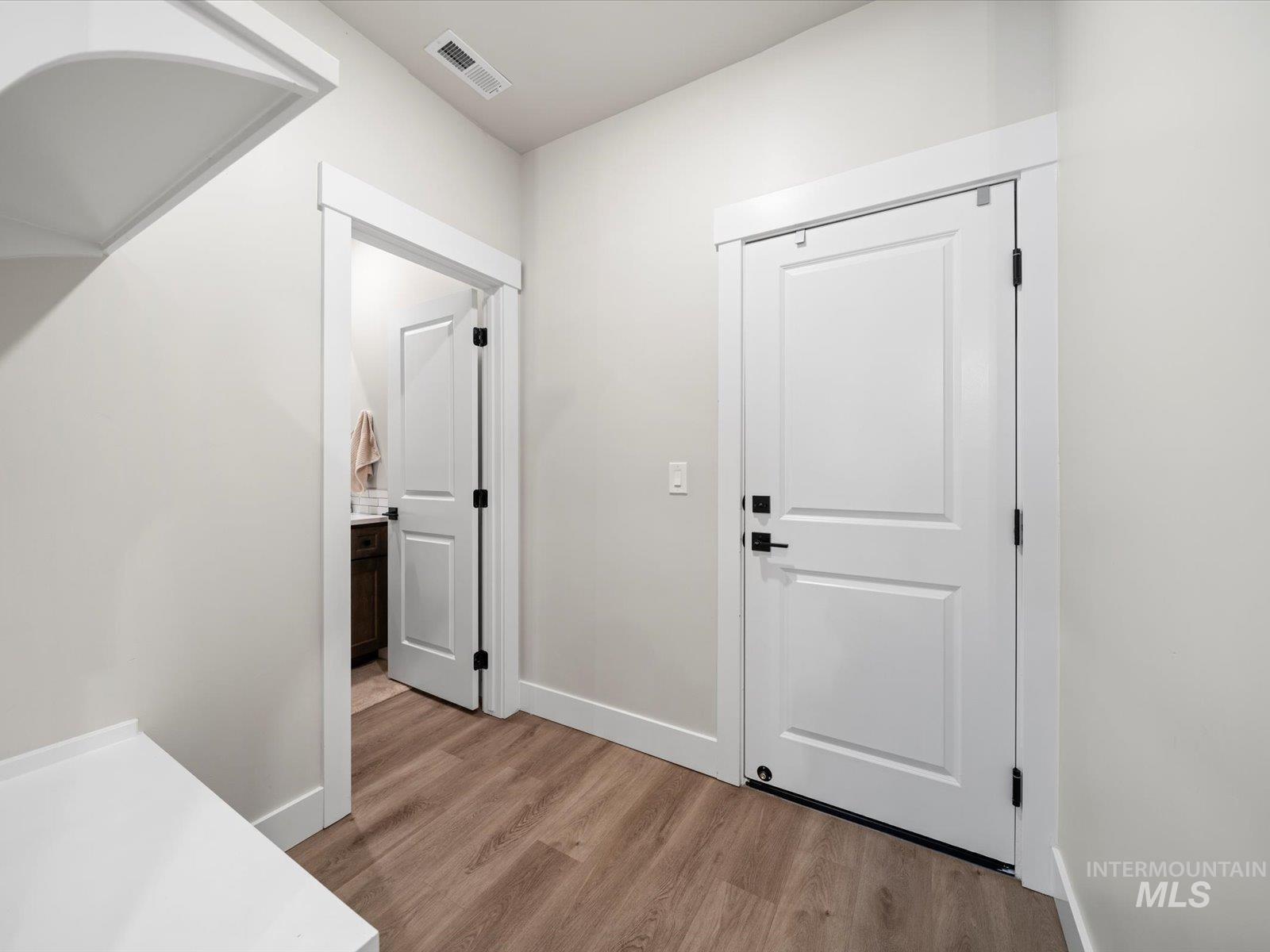 Foyer entrance featuring light wood-style floors and baseboards