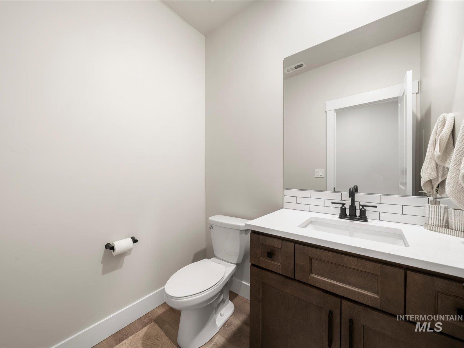 Bathroom featuring vanity and dark wood finished floors
