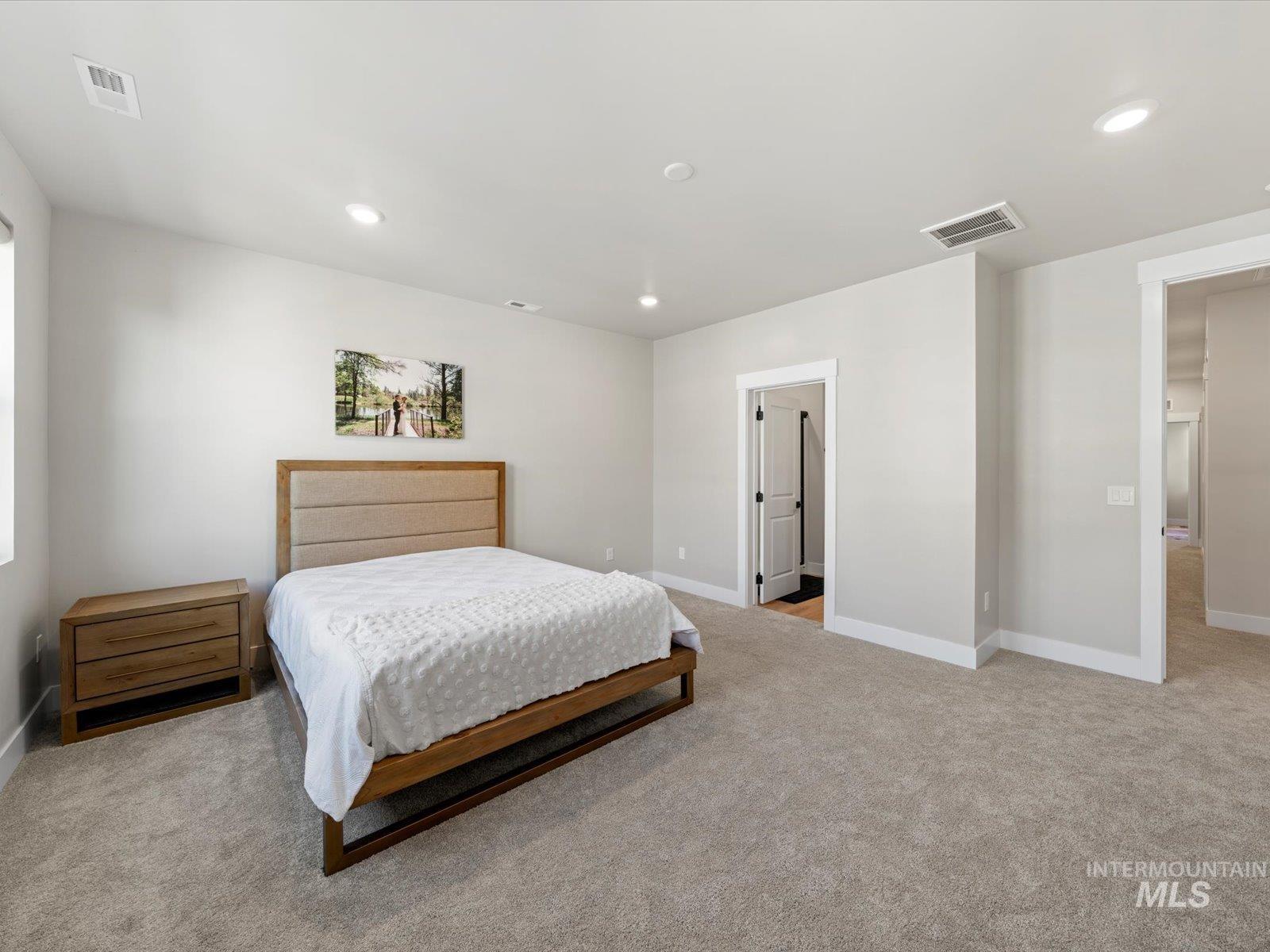 Bedroom featuring light carpet and recessed lighting