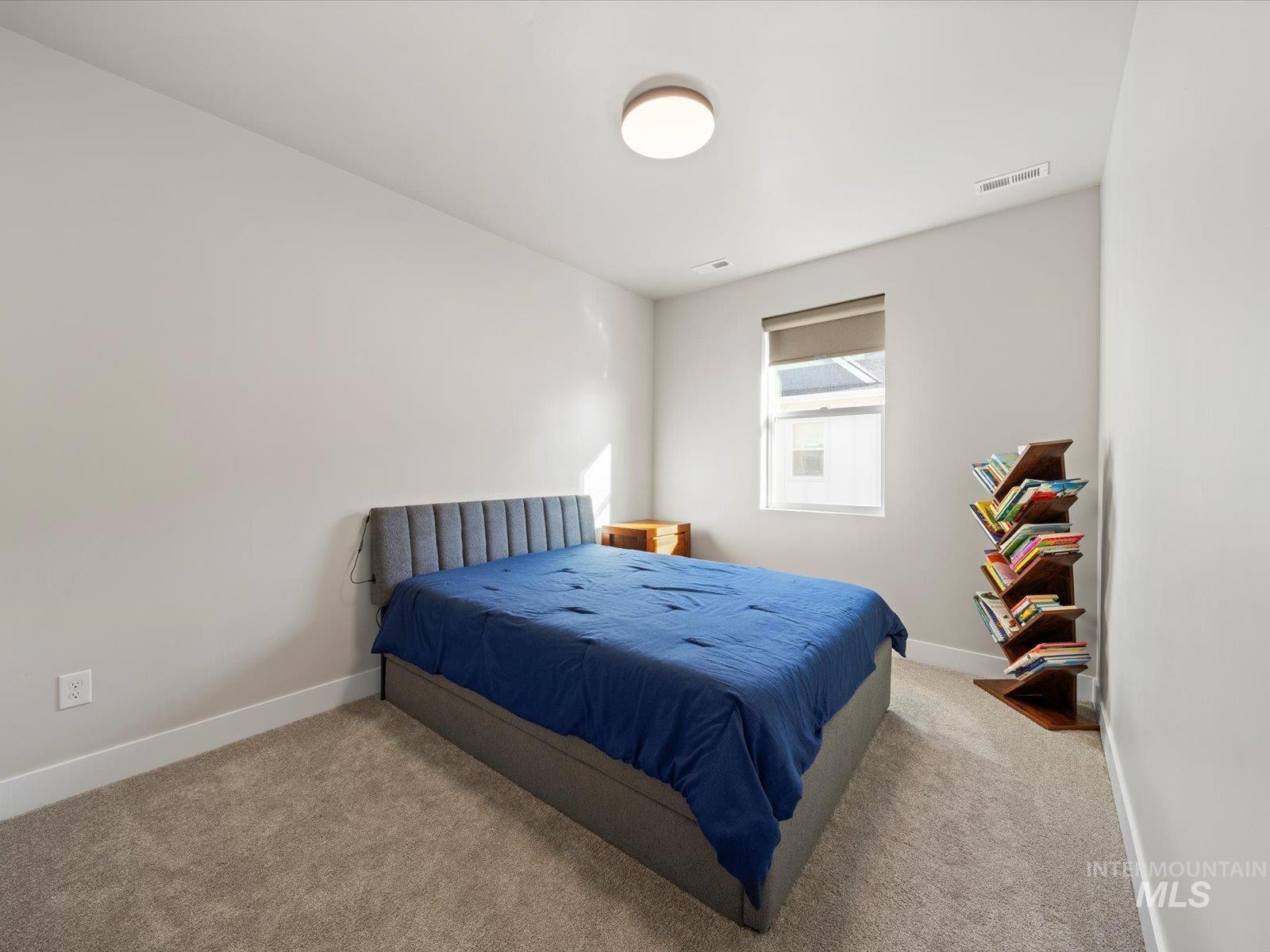 Carpeted bedroom with baseboards
