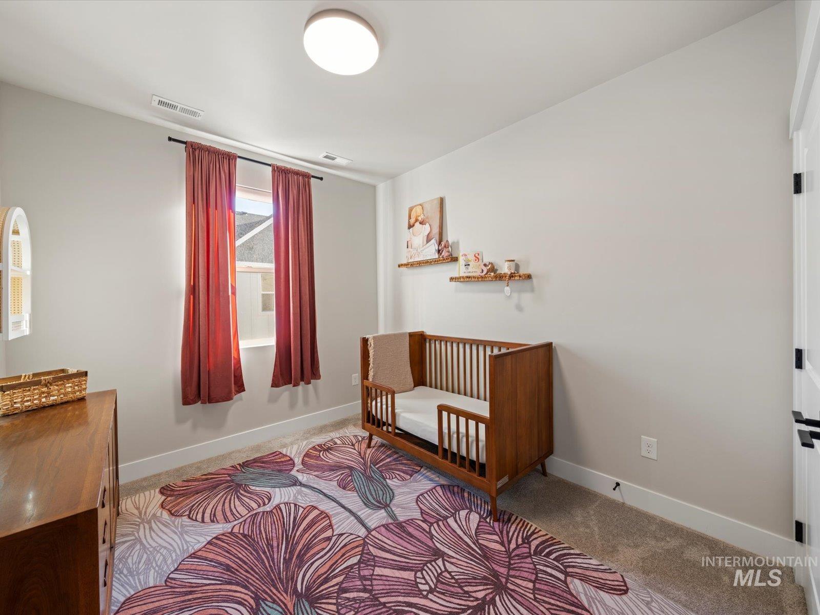 Bedroom with light carpet and baseboards