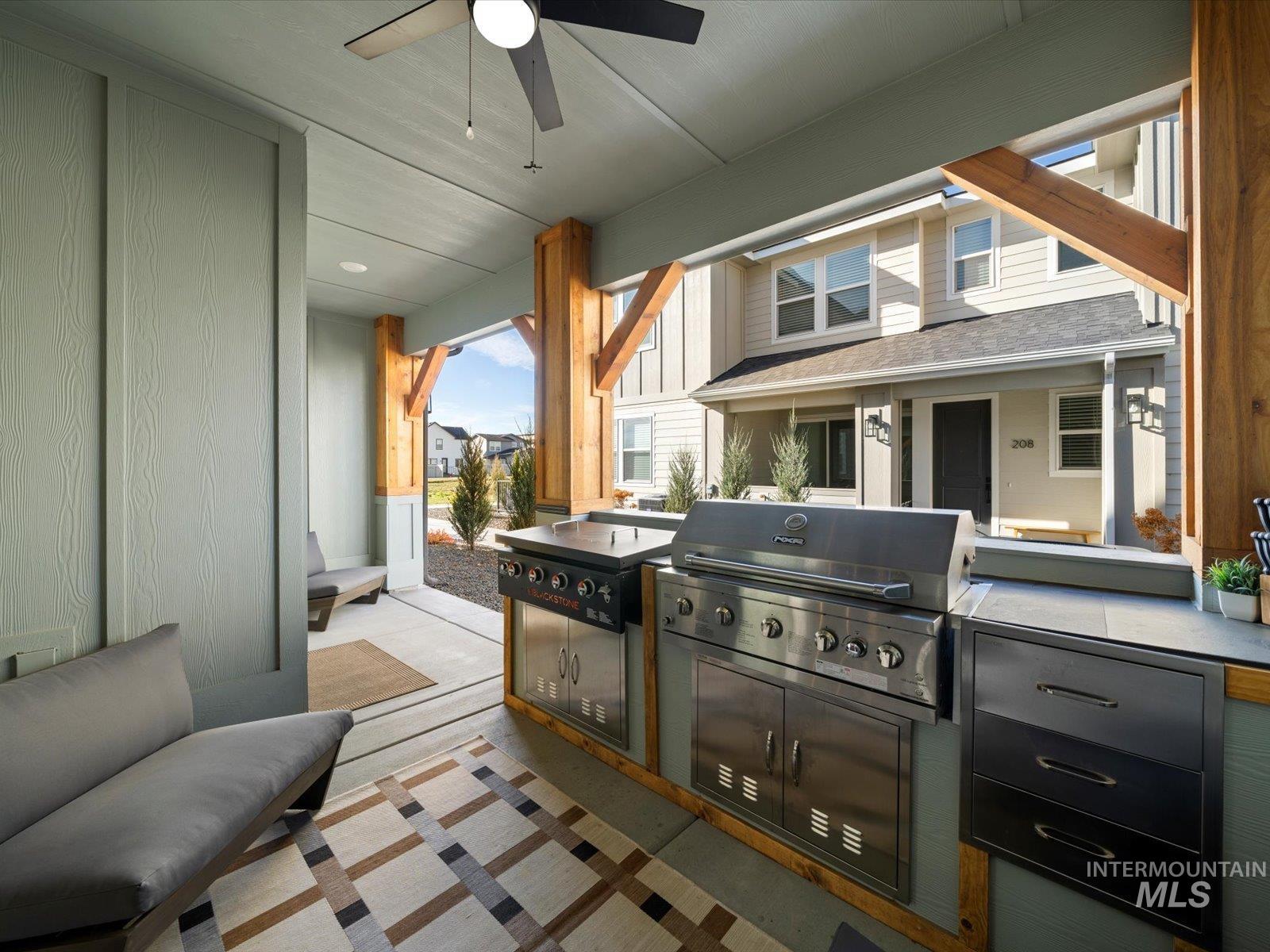 View of patio with a ceiling fan and exterior kitchen