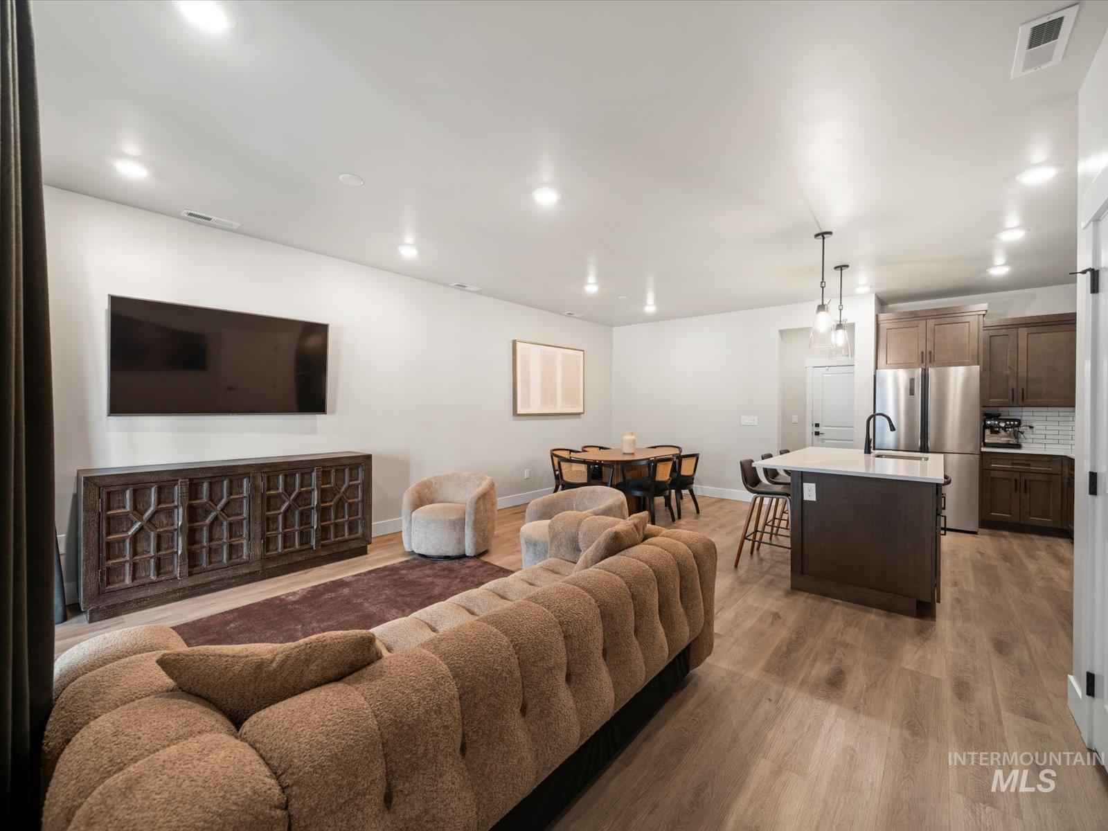 Living room featuring light wood-style flooring and recessed lighting