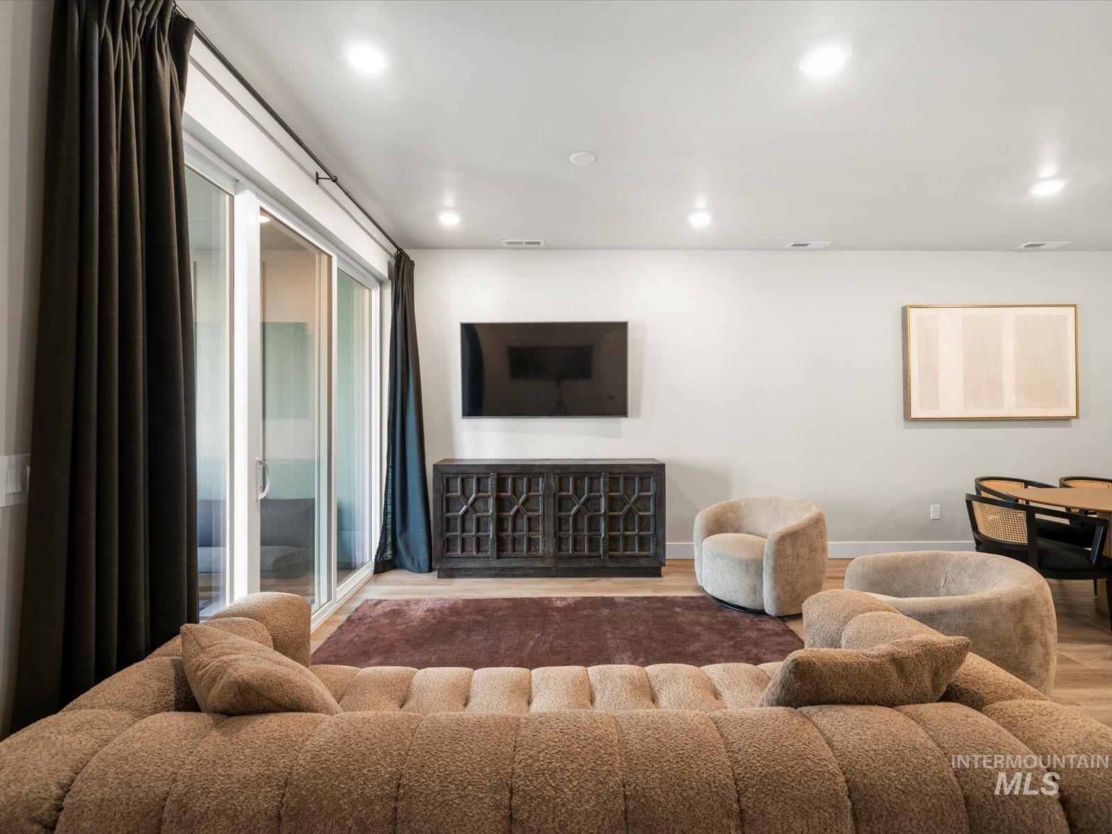Living room with recessed lighting and wood finished floors