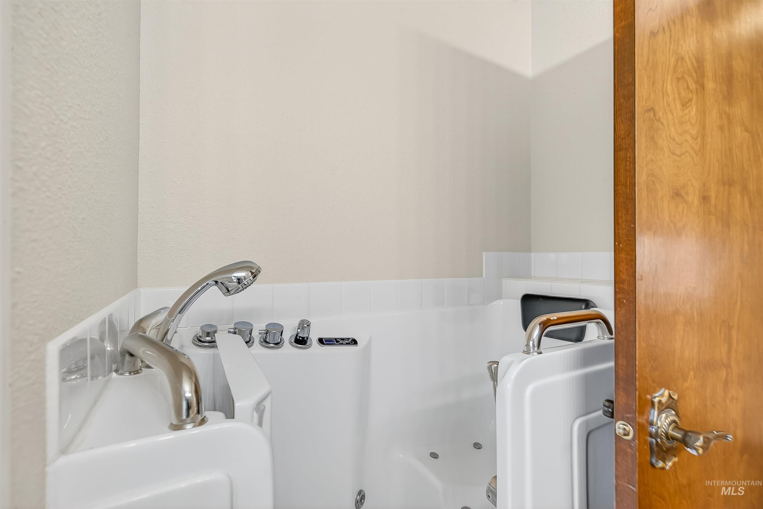 Bathroom featuring a tub with jets