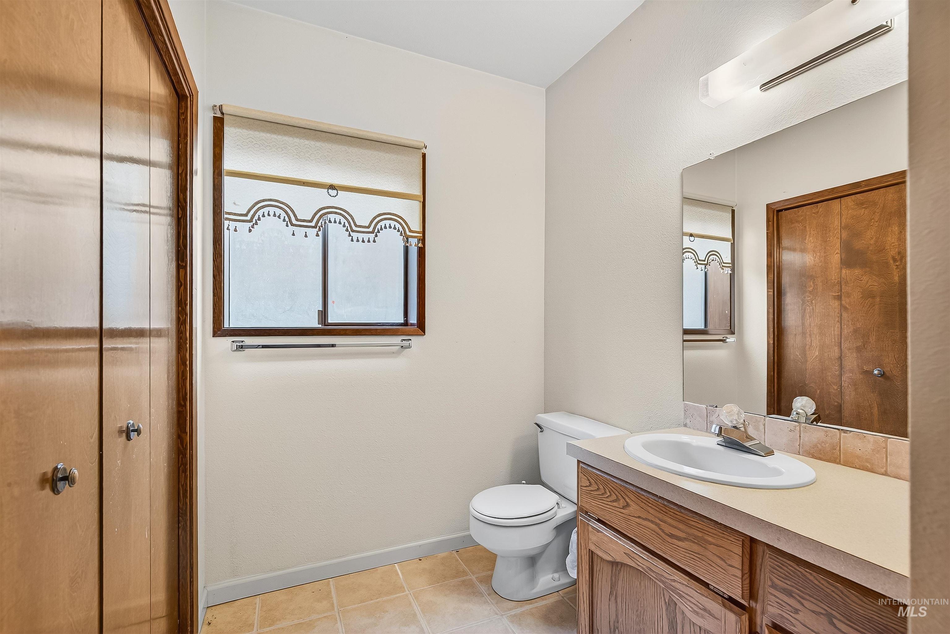 Bathroom featuring vanity and light tile patterned floors