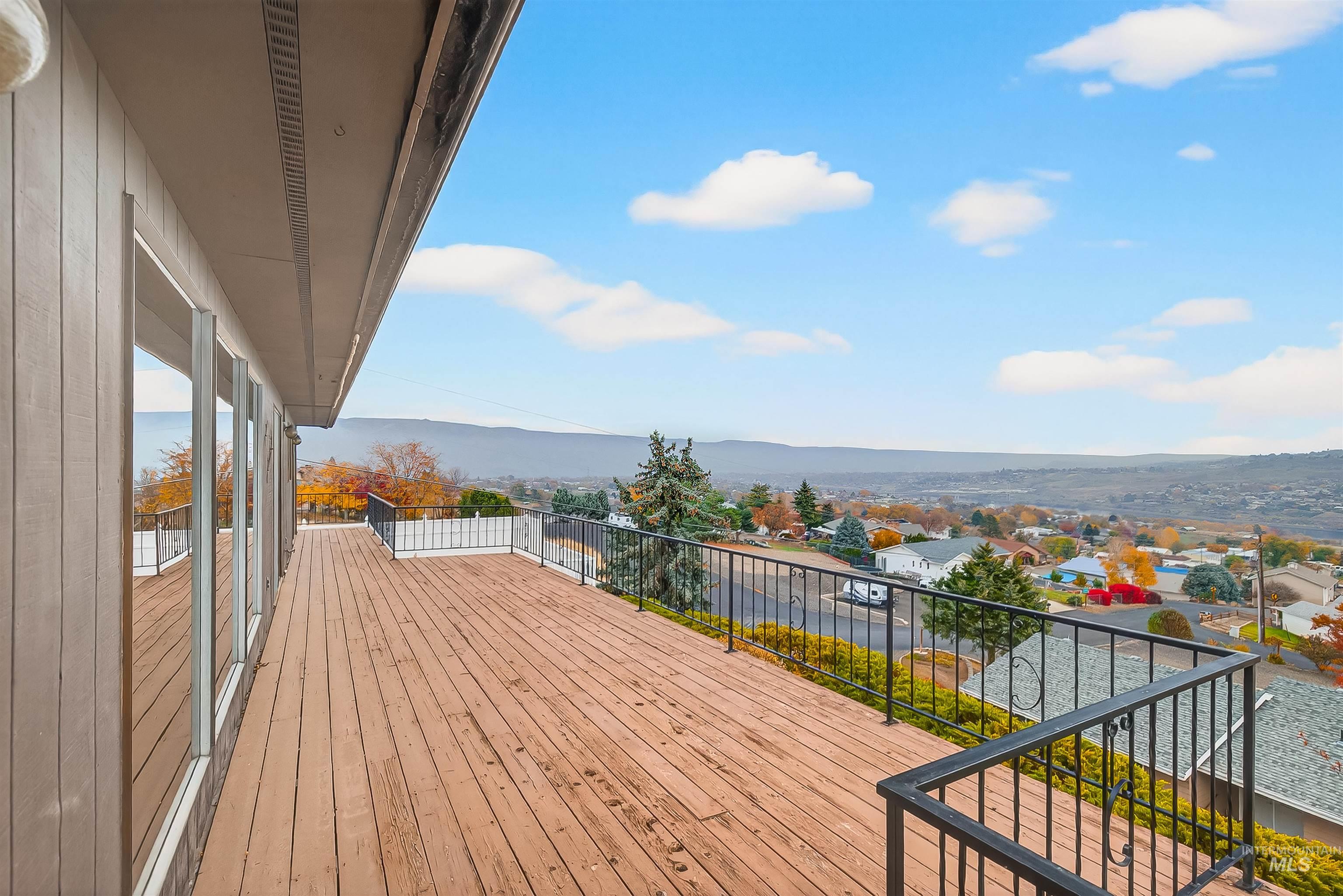 Wooden terrace featuring a mountain view and a residential view