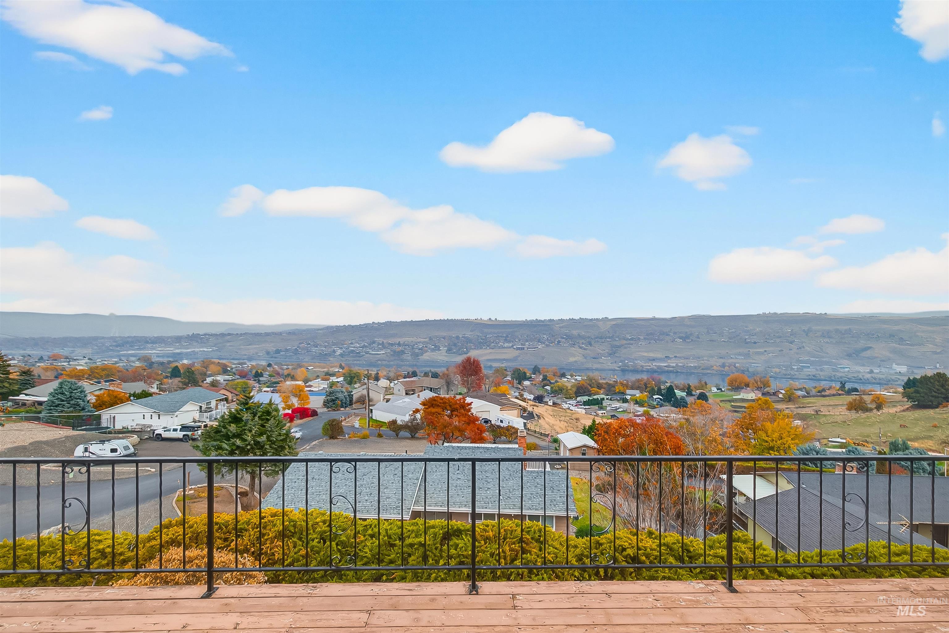 Water view featuring nearby suburban area and a mountain backdrop