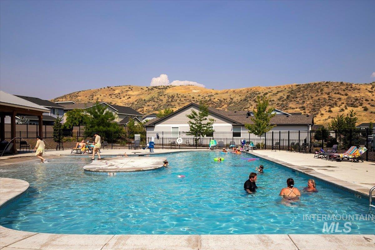 Community pool featuring a patio area and a mountain view