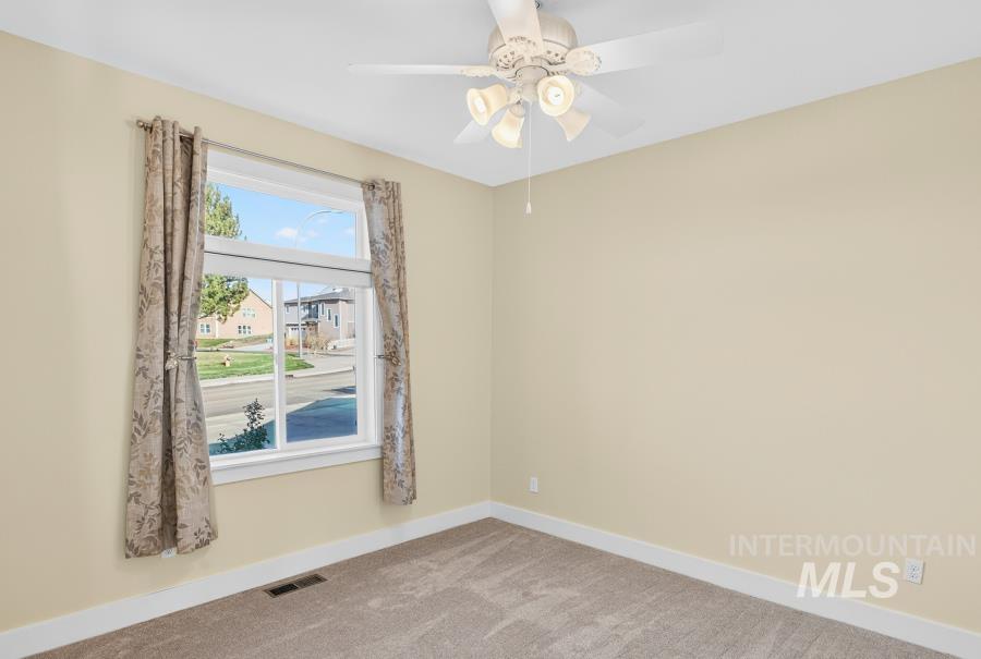 Spare room with carpet flooring and ceiling fan