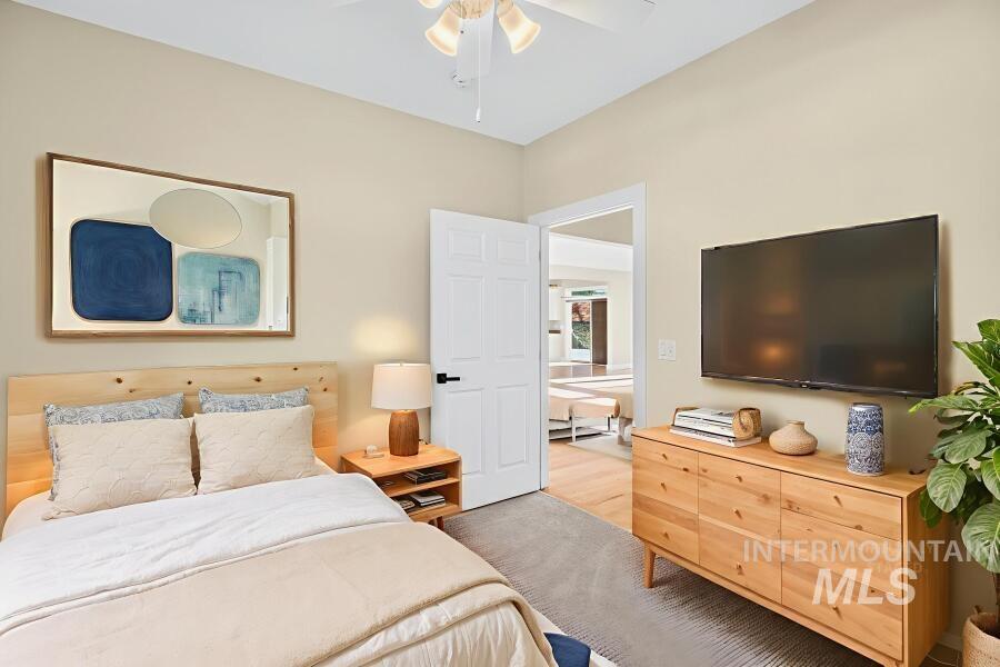 Bedroom featuring light colored carpet and a ceiling fan