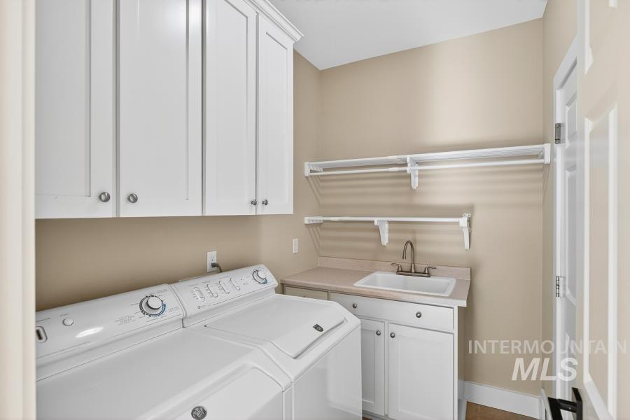 Laundry area with cabinet space and washing machine and clothes dryer