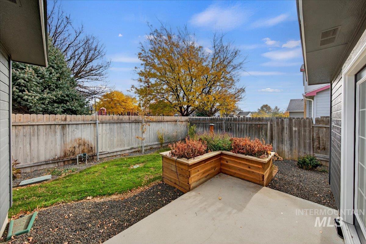 Fenced backyard with a patio