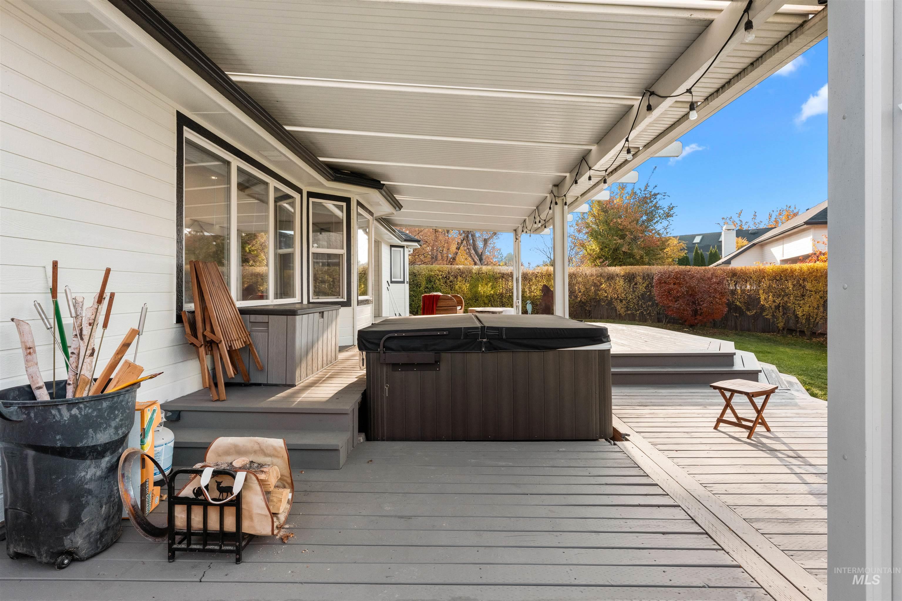 Wooden deck featuring a hot tub