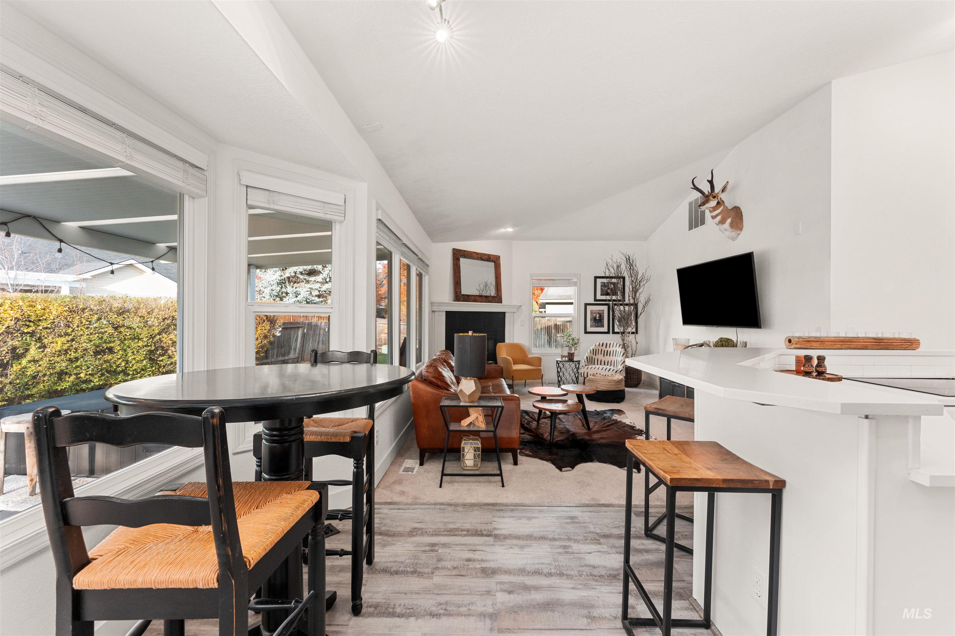 Dining room with vaulted ceiling and light wood finished floors
