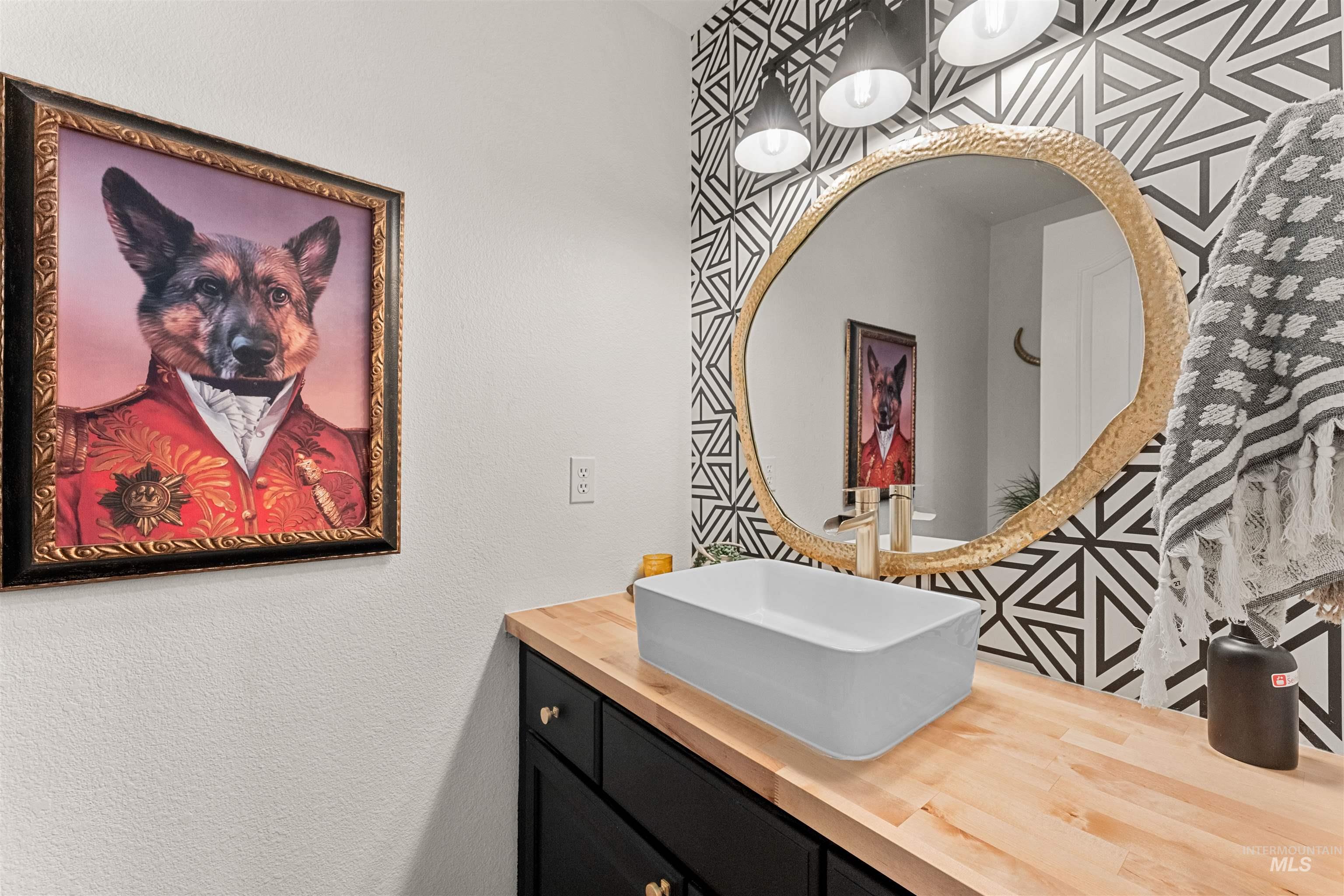Bathroom featuring vanity and a textured wall