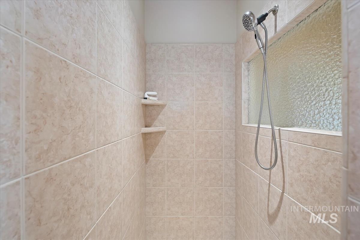 Bathroom view of a tile shower