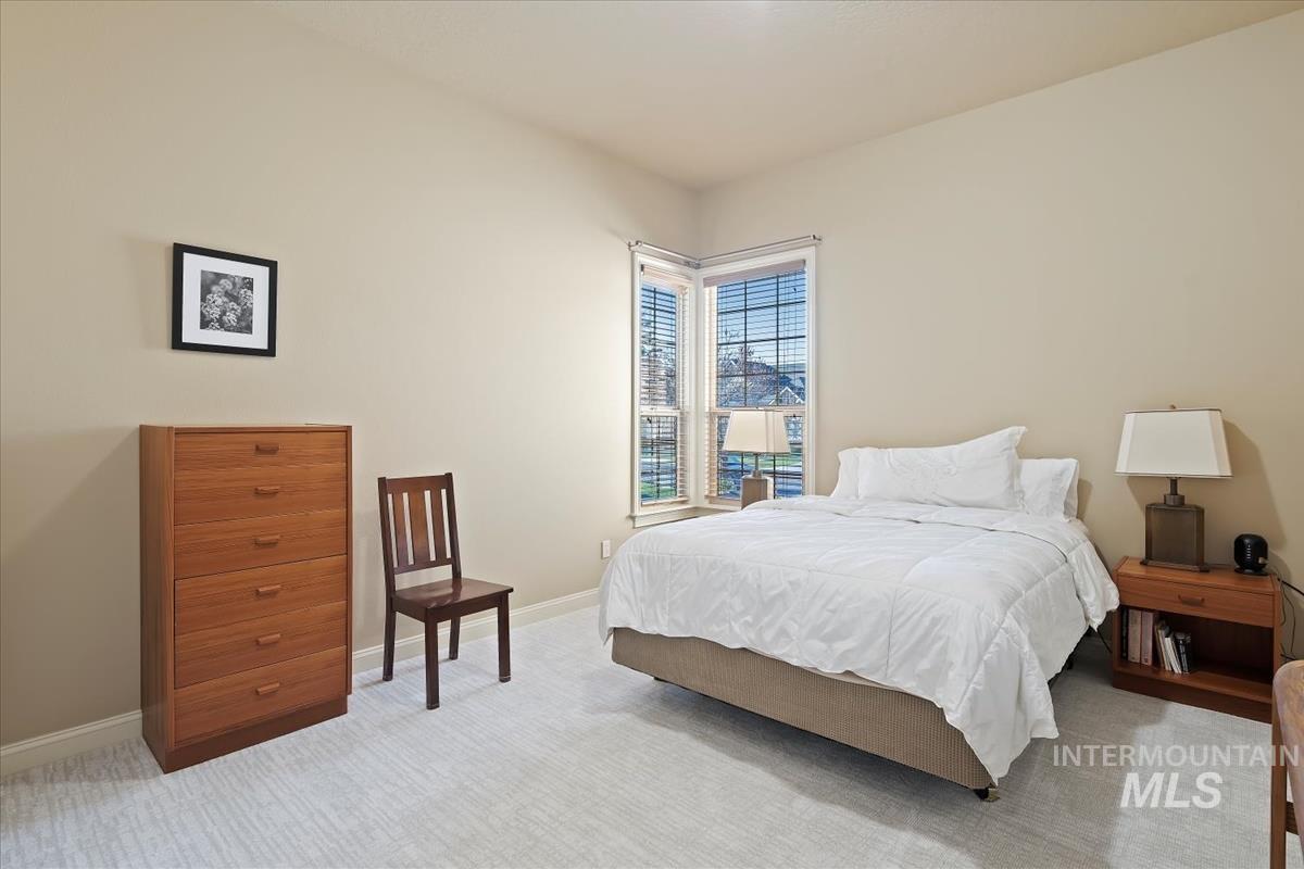 Bedroom featuring carpet flooring and baseboards