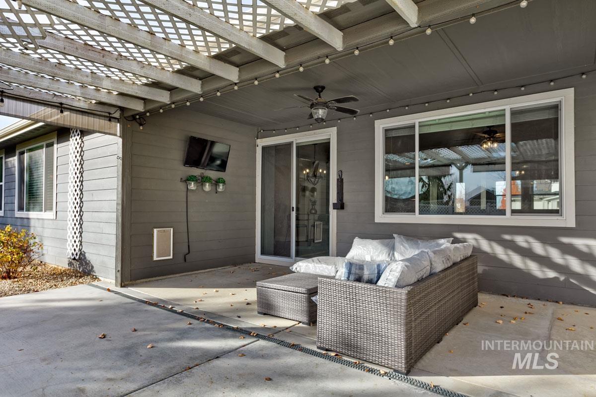 View of patio / terrace with a pergola, ceiling fan, and an outdoor living space