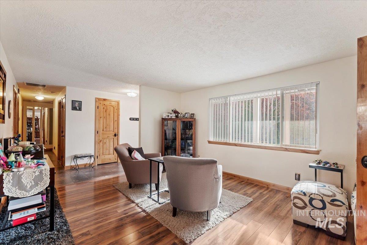 Living area with wood finished floors and a textured ceiling