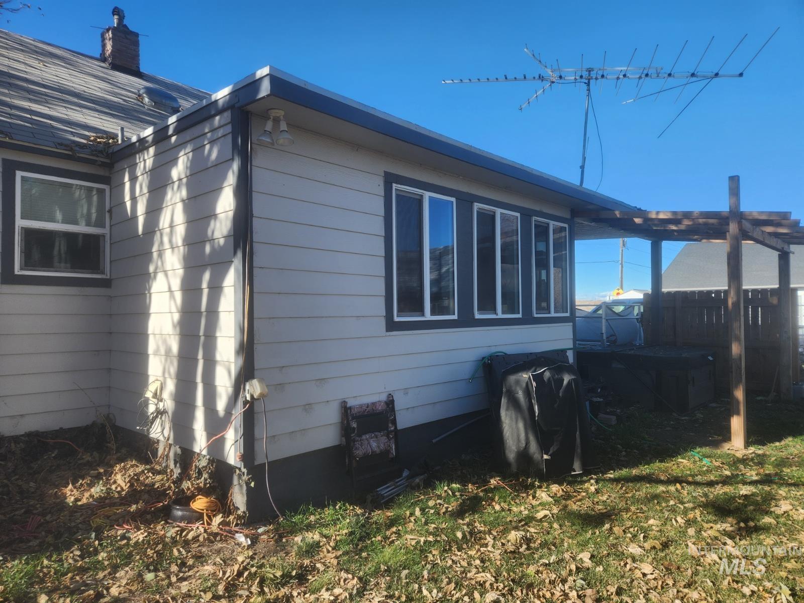 View of side of home featuring a chimney